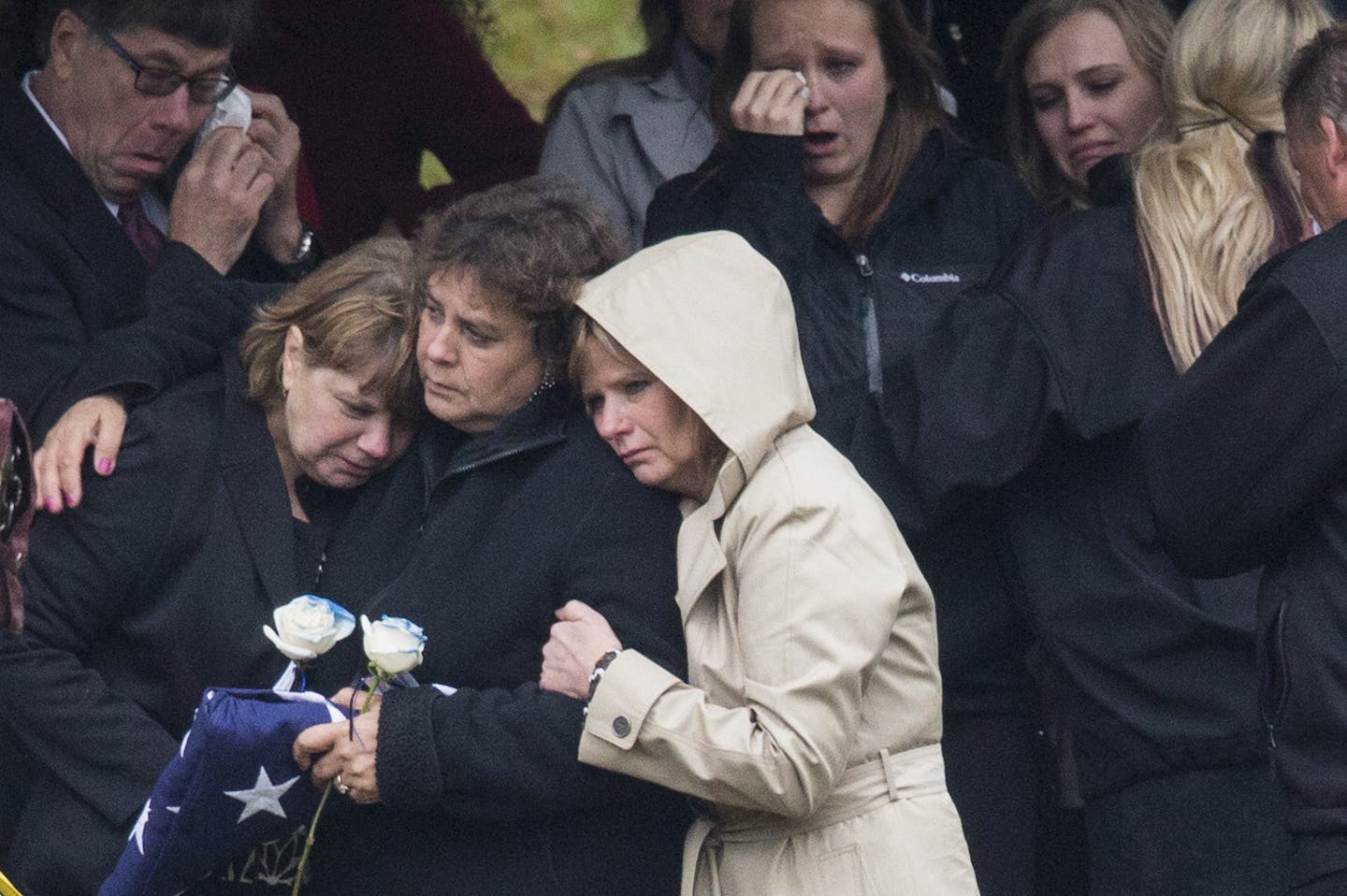 Loved ones comfort Kristi Sandberg during the burial of her husband Deputy Steven Sandberg at the Bennettville cemetery in Bennettville, Minn., on Friday, October 23, 2015. ] RENEE JONES SCHNEIDER &#x2022; reneejones@startribune.com