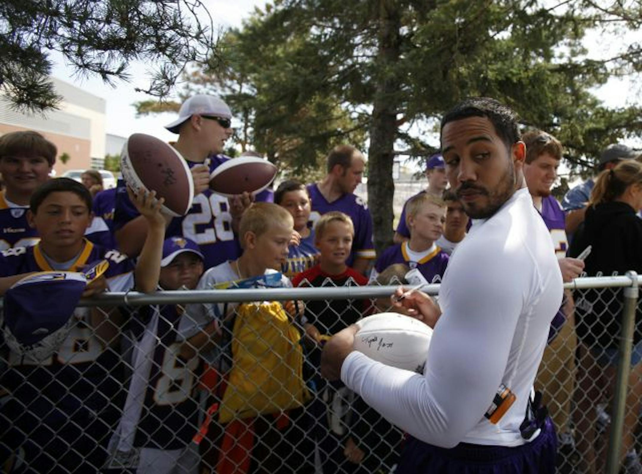 Vikings receiver Bobby Wade delved into less controversial pursuits Friday, signing a football.