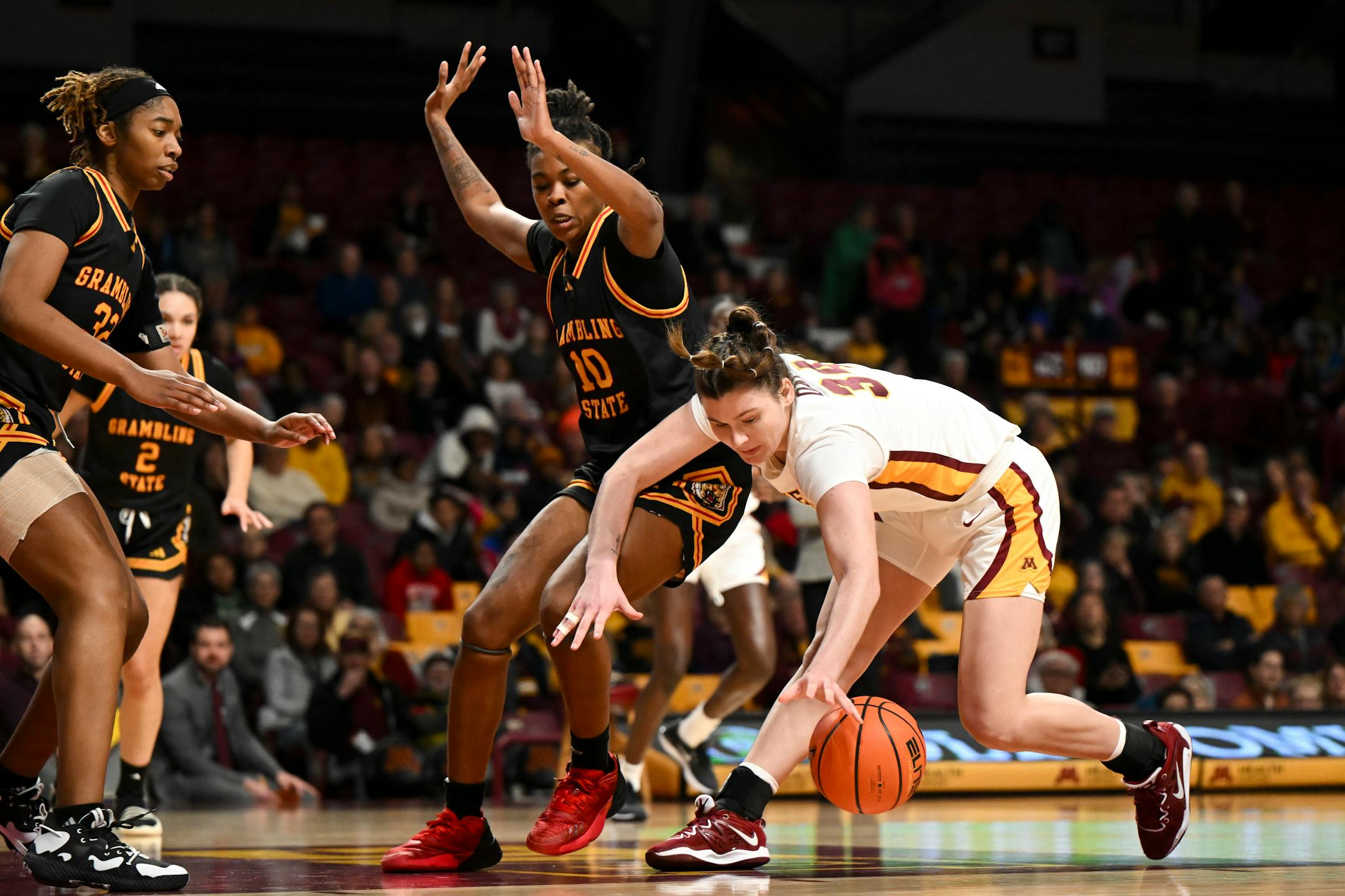 Minnesota Gophers forward McKynnlie Dalan (34) and Grambling Lady Tigers forward Brenda McKinney (10) battle for a loose ball in the second half.