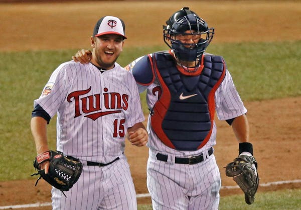 The American League closer, the Twins' Glen Perkins, and teammate Kurt Suzuki walked to join the rest of their teammates after the final out of the Al