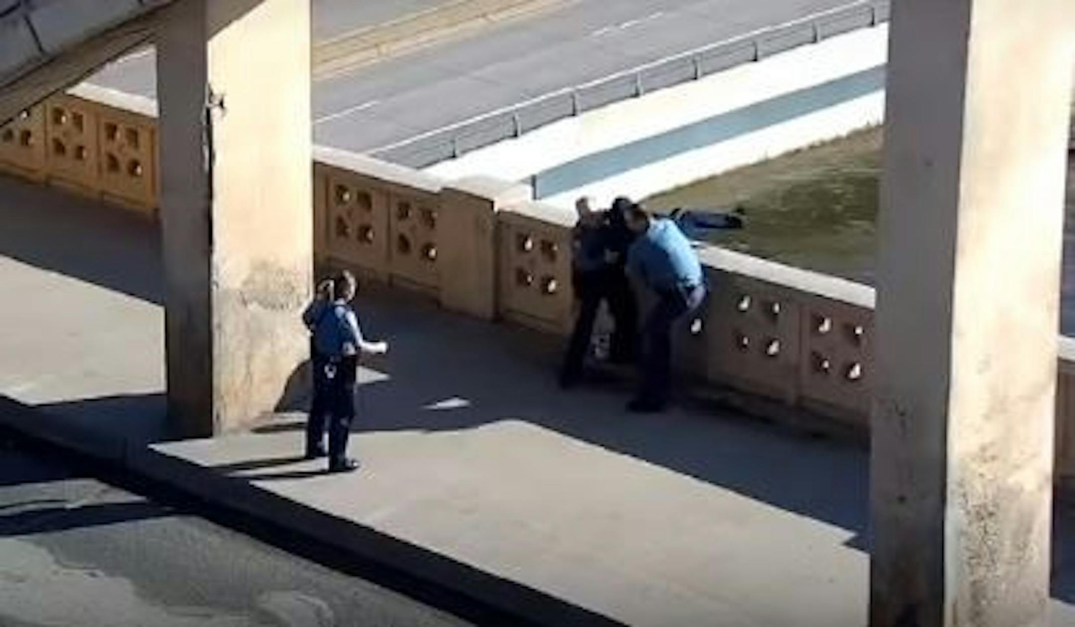 Police Chief Todd Axtell, left, and officer Frank Judge pulled the woman to safety as officer Gao Vang moved in to assist.