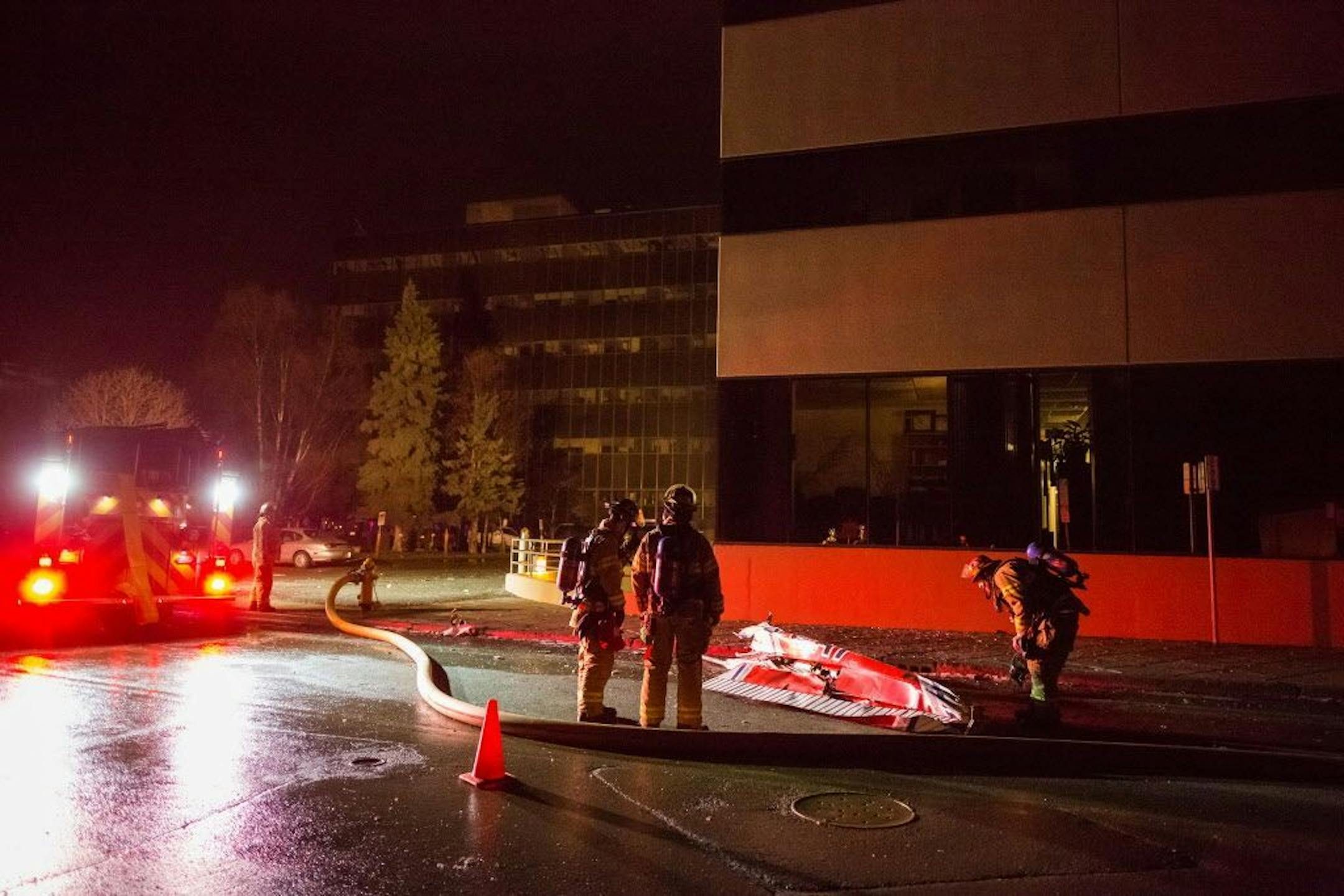 Anchorage Fire Department personnel secure the wreckage of a Civil Air Patrol Cessna 172S plane after it crashed into two buildings in downtown Anchorage, Alaska, early Tuesday morning, Dec. 29, 2015. Civil Air Patrol officials identified 1st Lt. Doug Demarest as the person killed in the crash, and said the flight was not sanctioned by the agency.