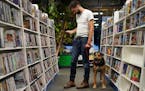 Garrett Fitzgerald browsed the DVDs for sale along with his housemate's dog Hondo at The Movies on 35th Street.