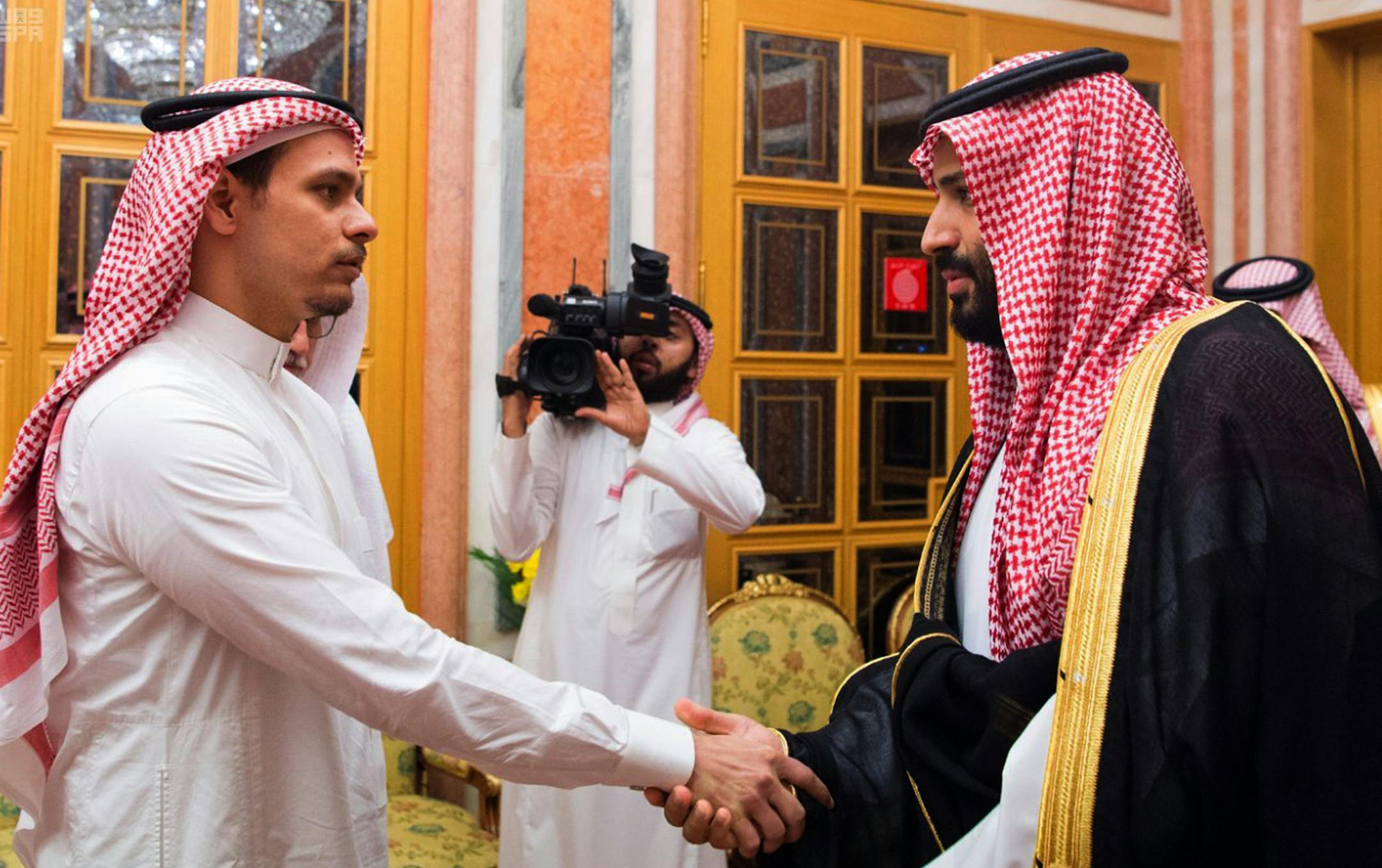 In this photo released by Saudi Press Agency, SPA, Saudi Crown Prince Mohammed bin Salman, right, shakes hands with Salah Khashoggi, a son, of Jamal Khashoggi, in Riyadh, Saudi Arabia, Tuesday, Oct. 23, 2018. Saudi Arabia, which for weeks maintained that Jamal Khashoggi had left the Istanbul consulate, on Saturday acknowledged he was killed there in a "fistfight." (Saudi Press Agency via AP)