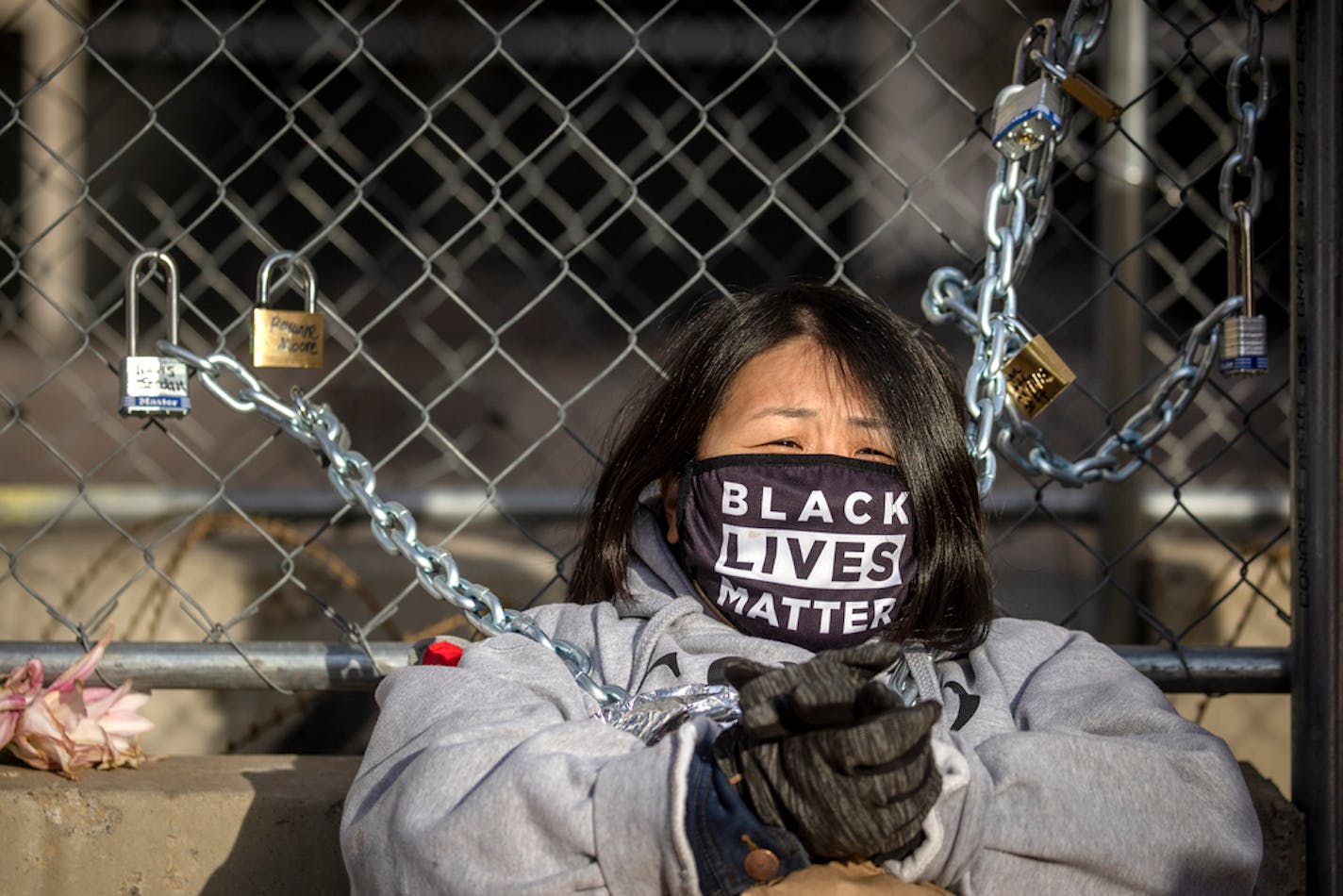 Kaia Hirt, cq, a Twin Cities teacher, remained chained to a fence outside the Hennepin County Government Center, Tuesday, March 30, 2021 in Minneapolis, MN. Hirt, with the "Good Trouble for Justice Group," did this to honor families of people who were murdered by the police. ] ELIZABETH FLORES • liz.flores@startribune.com