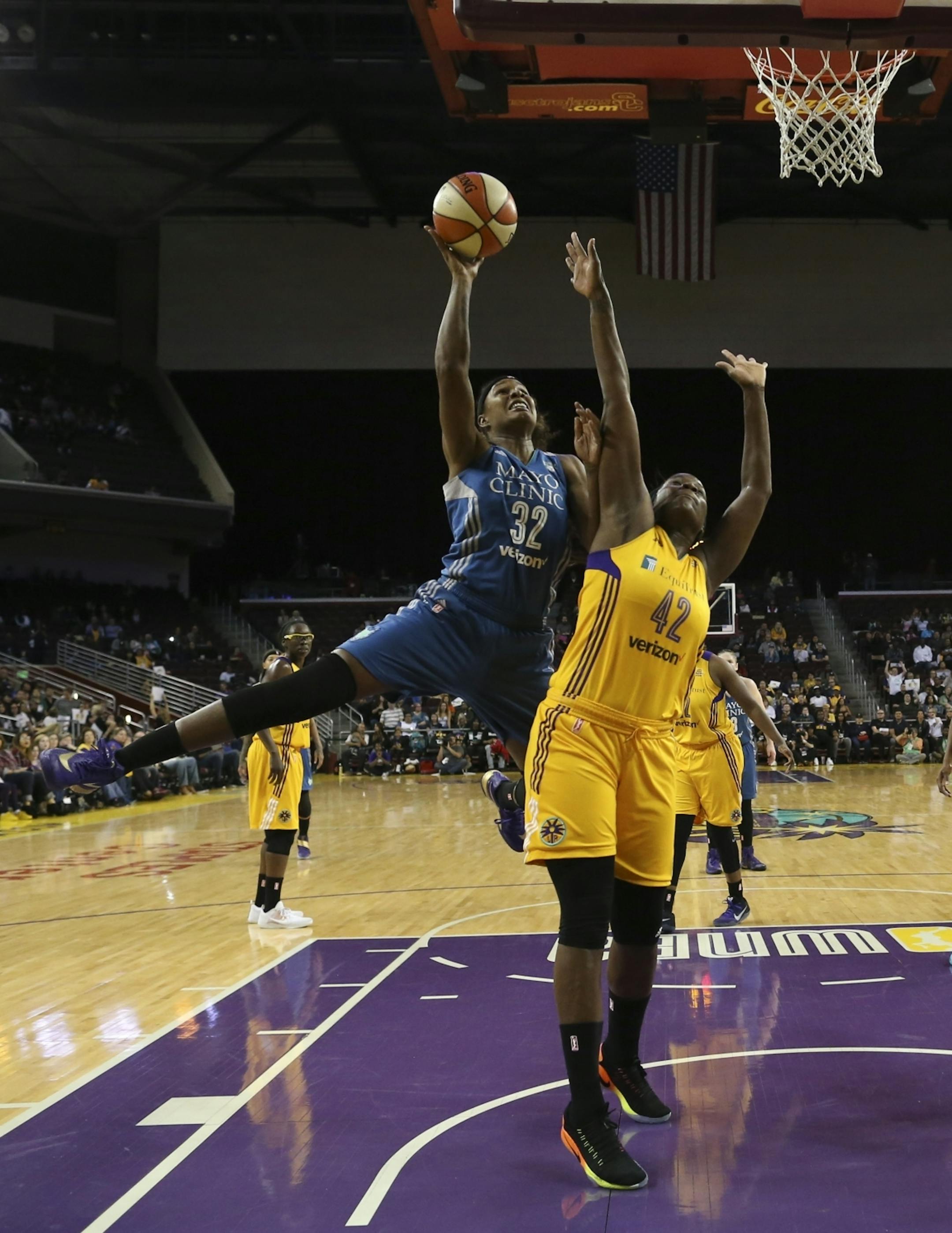Minnesota Lynx forward Rebekkah Brunson (32) put up a first half shot over Los Angeles Sparks center Jantel Lavender (42).