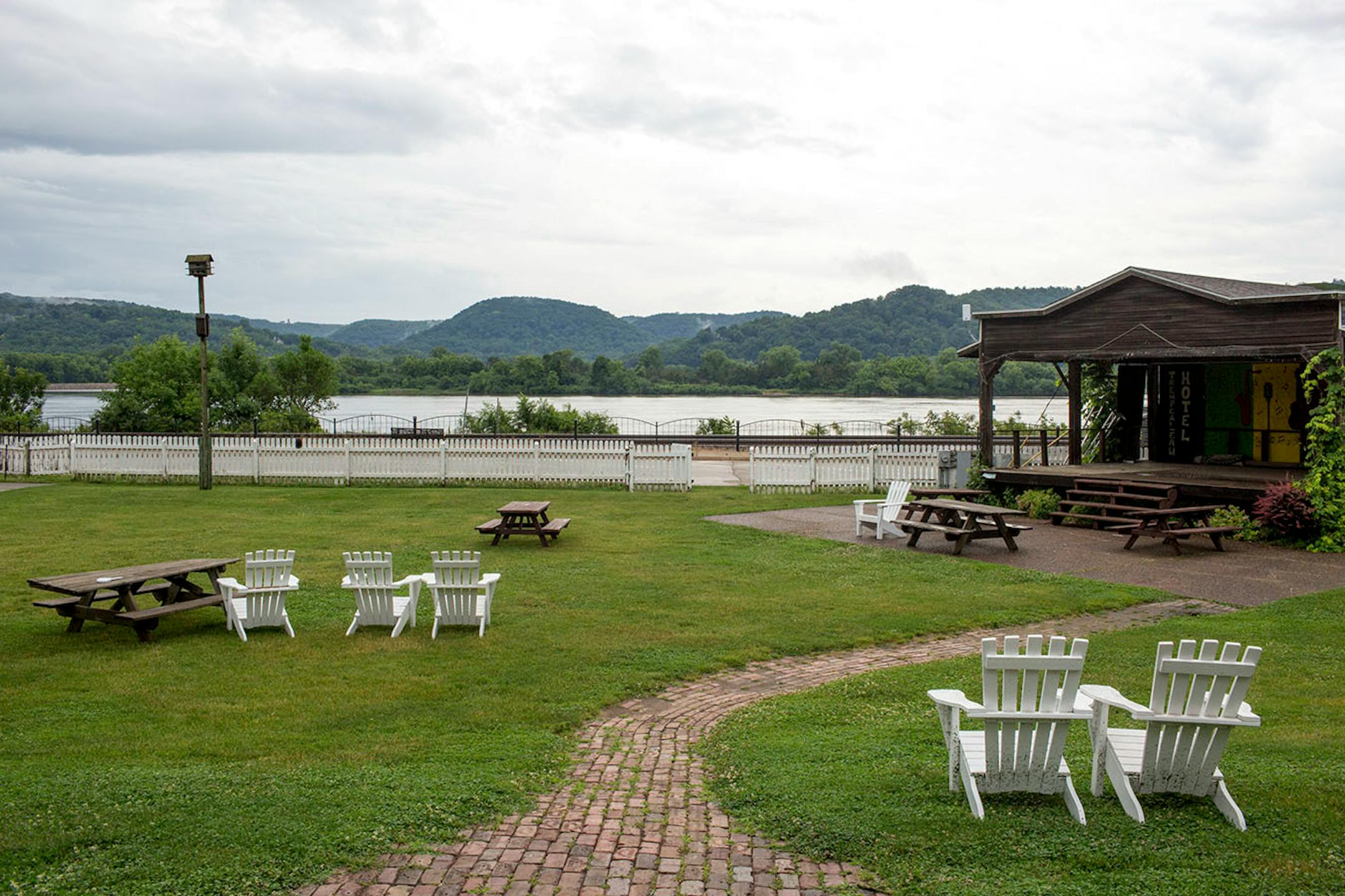 Adirondack chairs look out to the Mississippi River at the Trempealeau Hotel lawn. ] COURTNEY PEDROZA • courtney.pedroza@startribune.com June 22-24, 2017; Wisconsin restaurants, cafes, bars, bakeries and breweries; Dining along the Mississippi River.