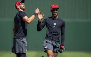 Carlos Correa and Byron Buxton high-fived last month at Hammond Stadium.