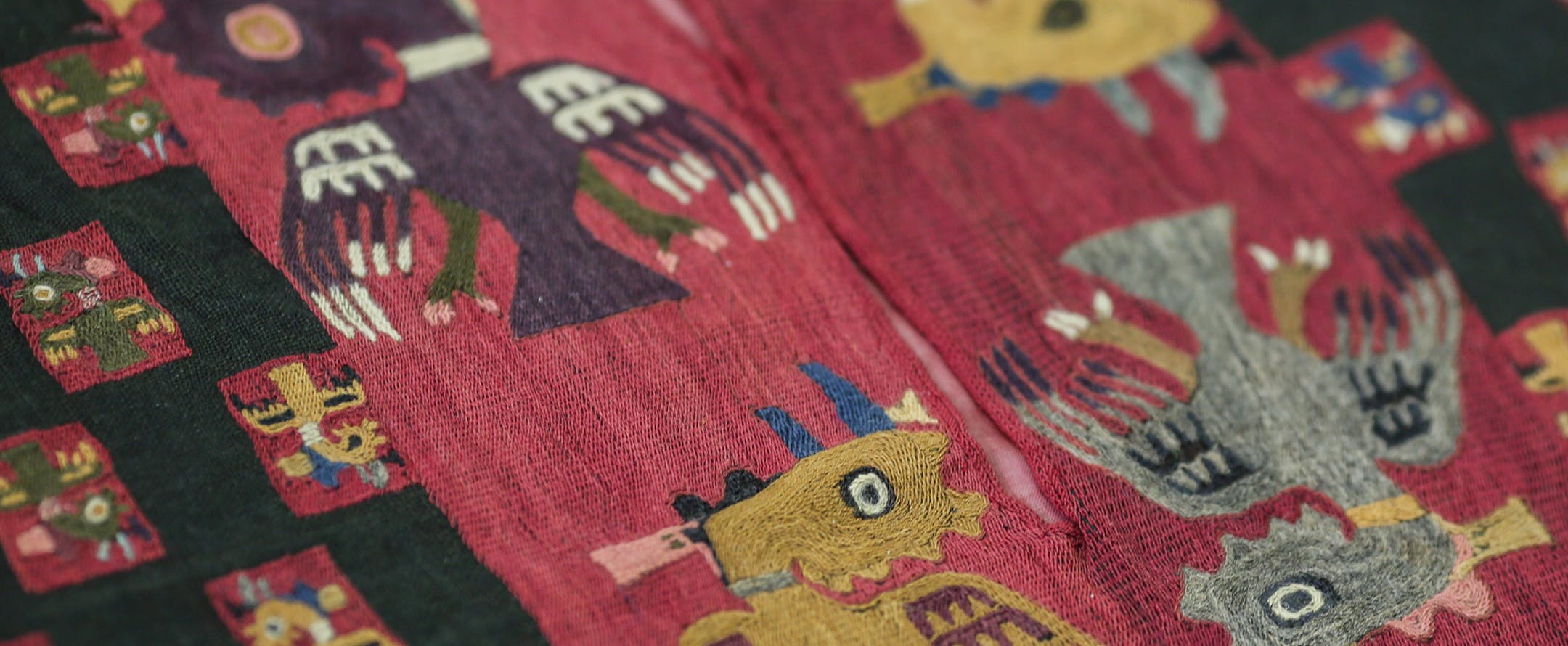 The detail of a Paracas textile poncho is displayed during a media presentation, at the National Museum of Archaeology, Anthropology and History of Peru in Lima. Peru, Monday, June 16, 2014. The poncho is among the first batch of ancient Paracas textiles that Sweden is returning to Peru 80 years after they were smuggled out by diplomat Sven Karell. In the early 1930s the Swedish consul had secreted them out of Peru after they were discovered in the Paracas Peninsula, a desert south of Lima where