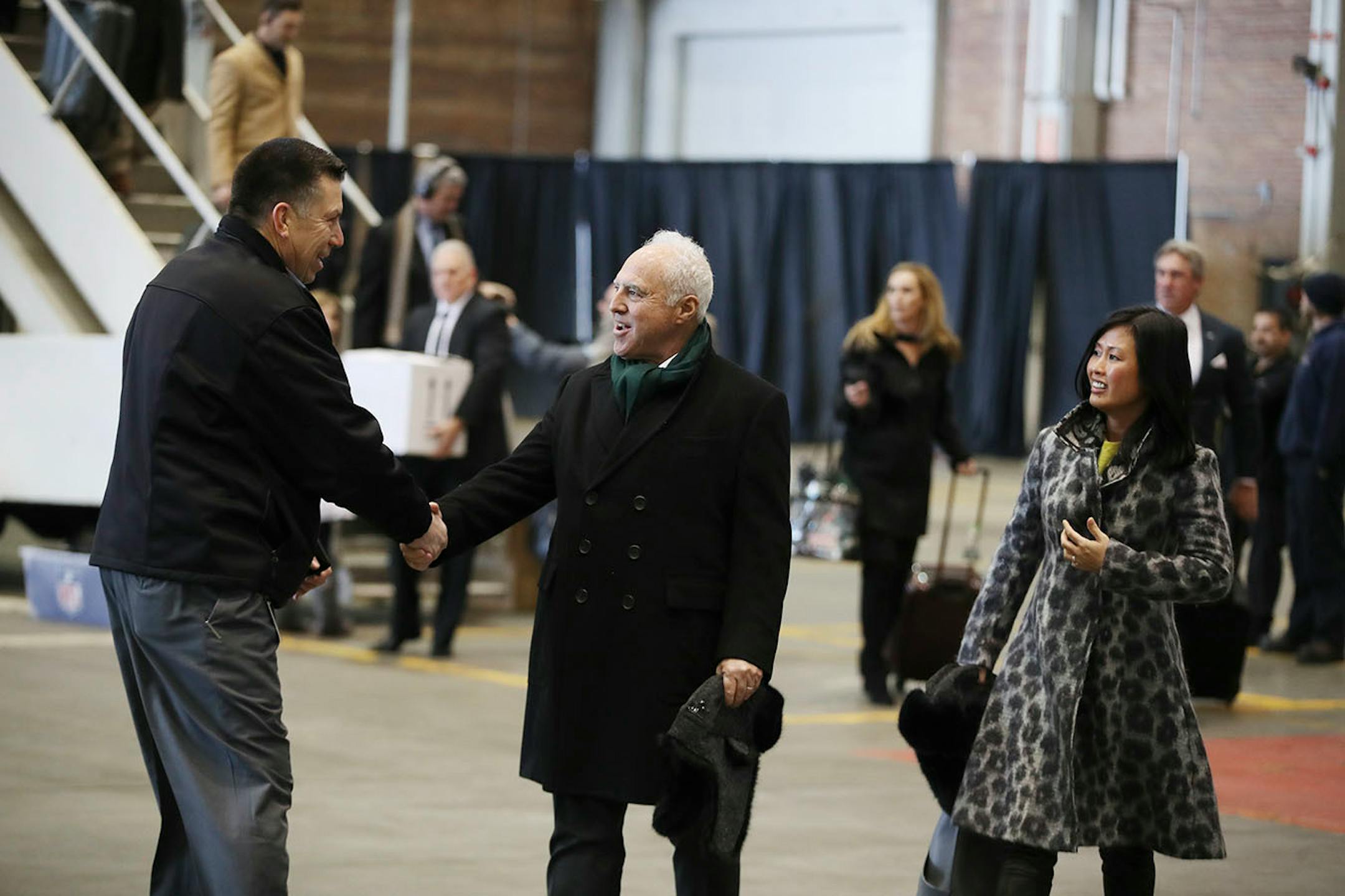Jeffrey Lurie (center) with his wife Tina Lai owner of the NFC Champions Philadelphia Eagles and his team arrived at MSP Airport Delta Airlines Maintenance Hangars 7 & 8 Sunday January 28, 2017 in St. Paul, MN.