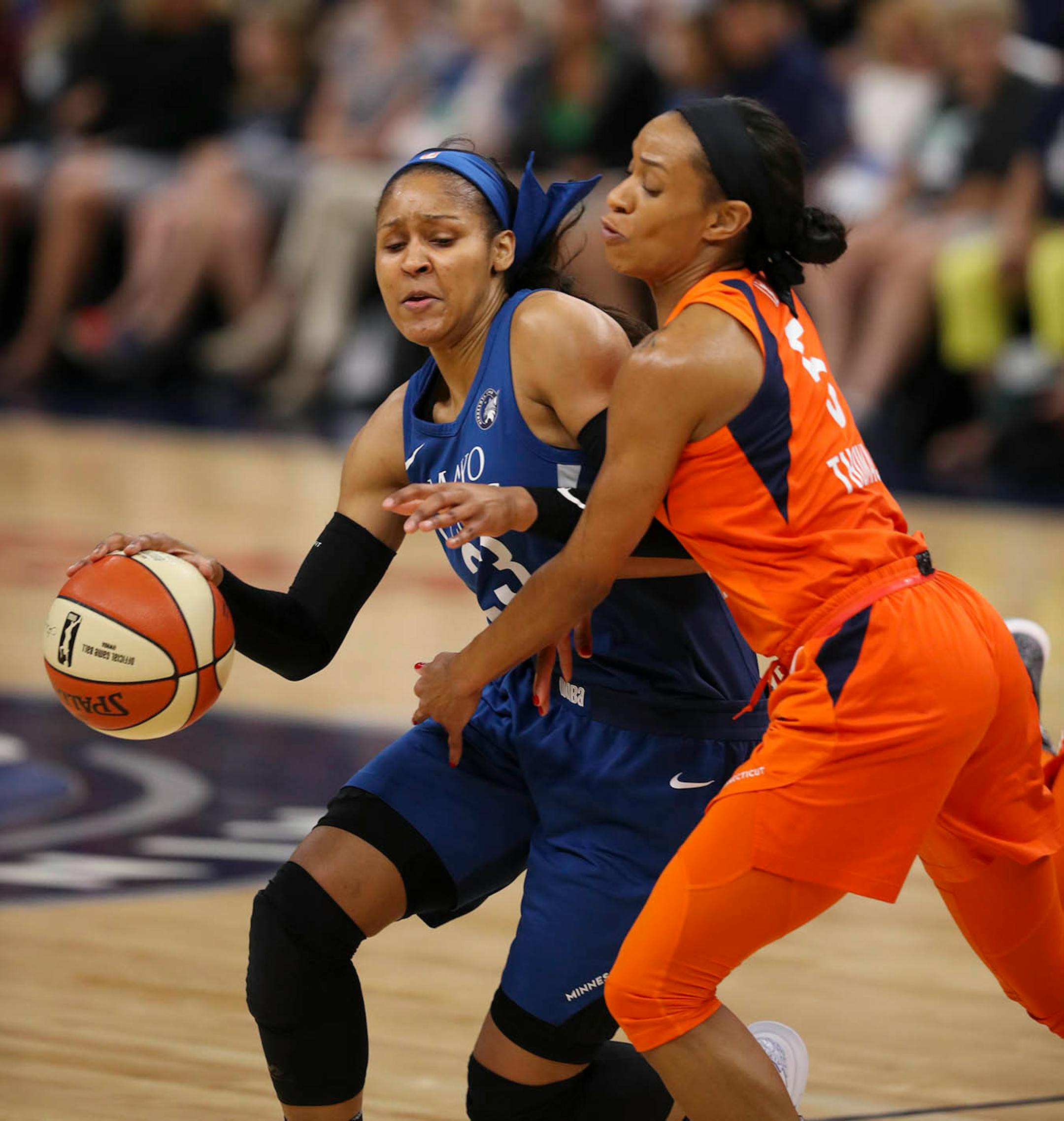 Minnesota Lynx forward Maya Moore (23) tried to drive around Connecticut Sun guard Jasmine Thomas (5) in the first quarter.