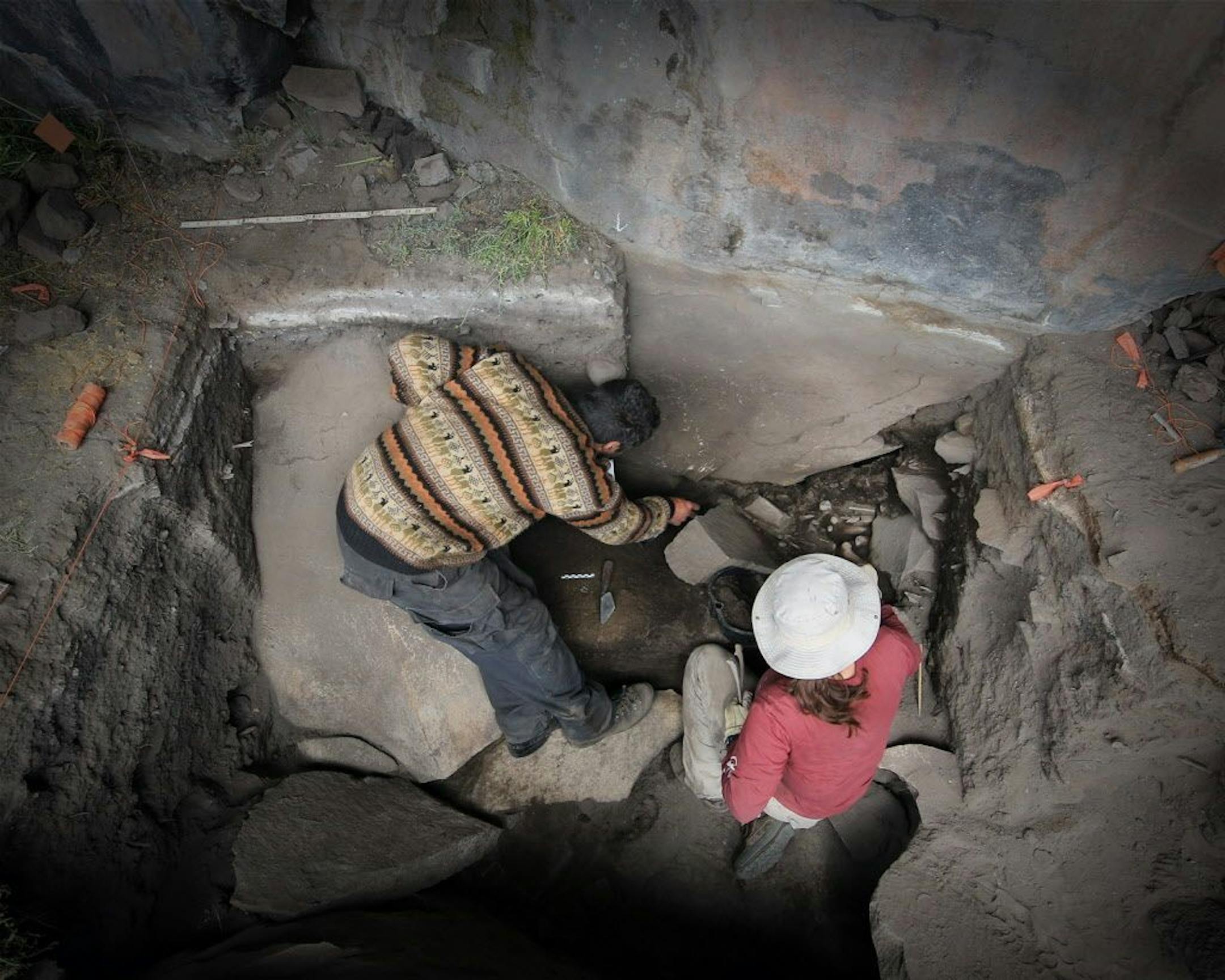 This undated image provided by journal Science shows Kurt Rademaker and Sonia Zarrillo during excavations at Cuncaicha rock shelter in the Peruvian Andes.