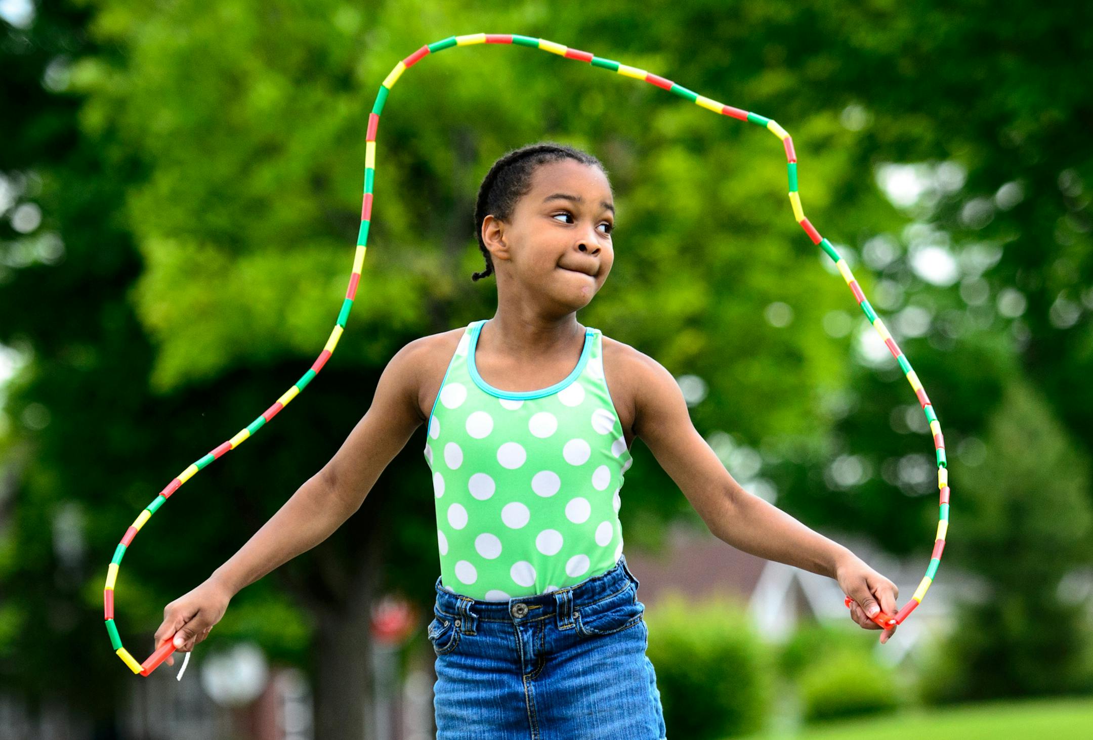 Shania Elliott, 6 strung together her own jump rope at the Pop Up Park in Jordan Park in North Minneapolis. She then tried it out. One of the free activities was to string together jump ropes. ] GLEN STUBBE * gstubbe@startribune.com Tuesday June 17, 2014