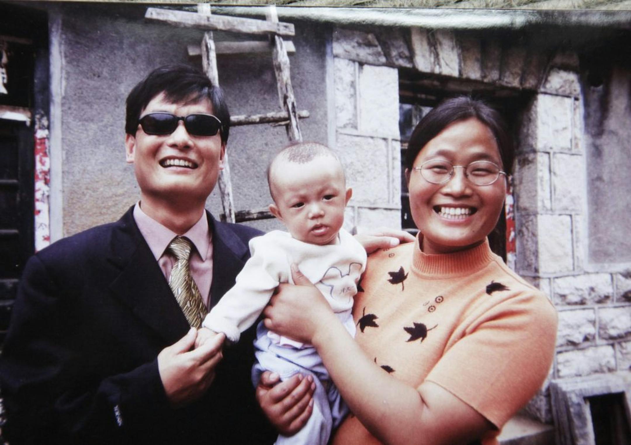 In this 2005 photo provided by Joan Lebold Cohen, Chinese legal activist Chen Guangcheng, left, and his wife, Yuan Weijing, hold their son in Shandong province, China.