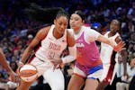 Team USA's A'ja Wilson (9) drives past Team WNBA's Dearica Hamby, front right, during the first half of the WNBA All-Star Game on Saturday, July 20, 2