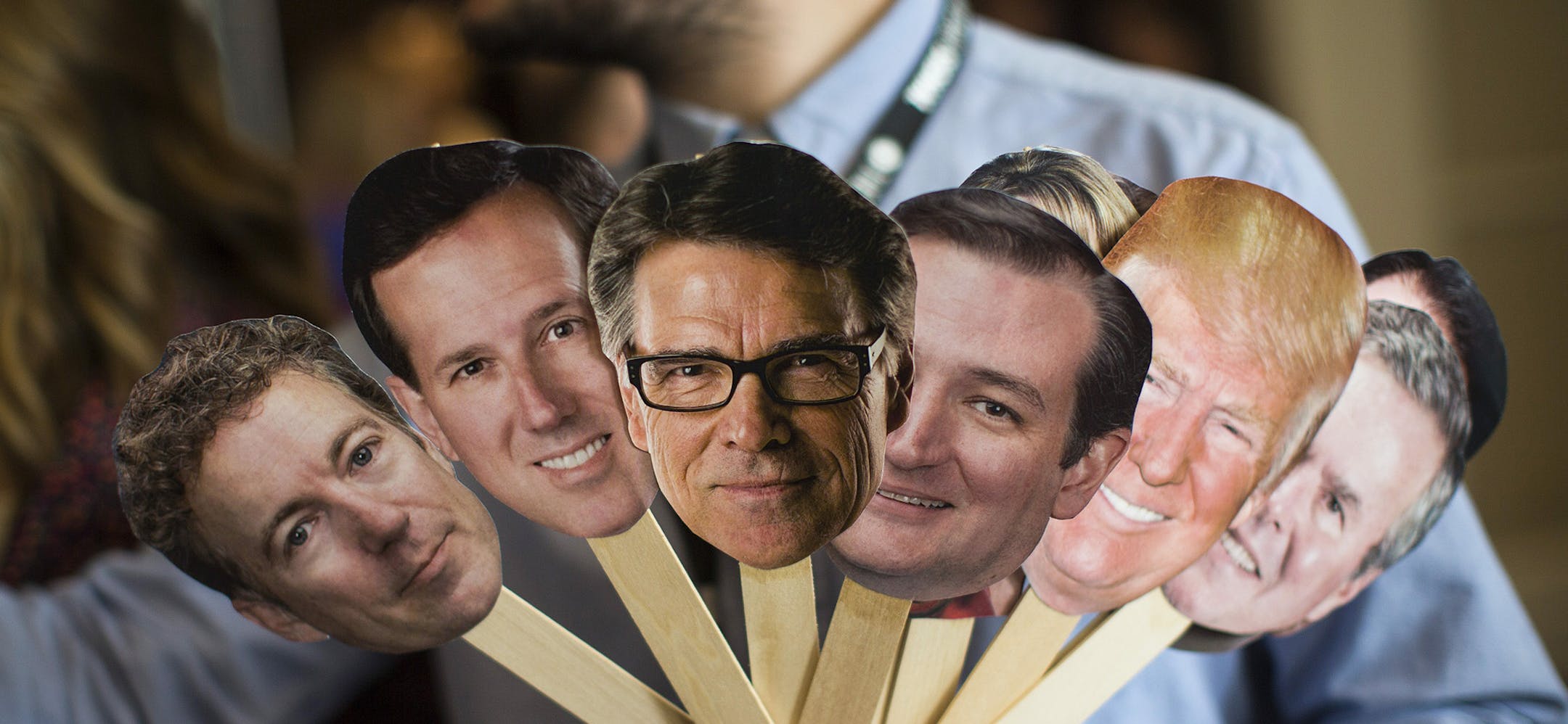 FILE -- A man interviewing attendees holds photo cutouts of 2016 presidential hopefuls at the Conservative Political Action Conference in National Harbor, Md., Feb. 26, 2015. The announcements by Fox News and CNN that they will limit the first two debates to candidates who rank in the top 10 in national polls has candidates on the edge pushing to get their numbers up. (Jabin Botsford/The New York Times) ORG XMIT: MIN2015061211394925