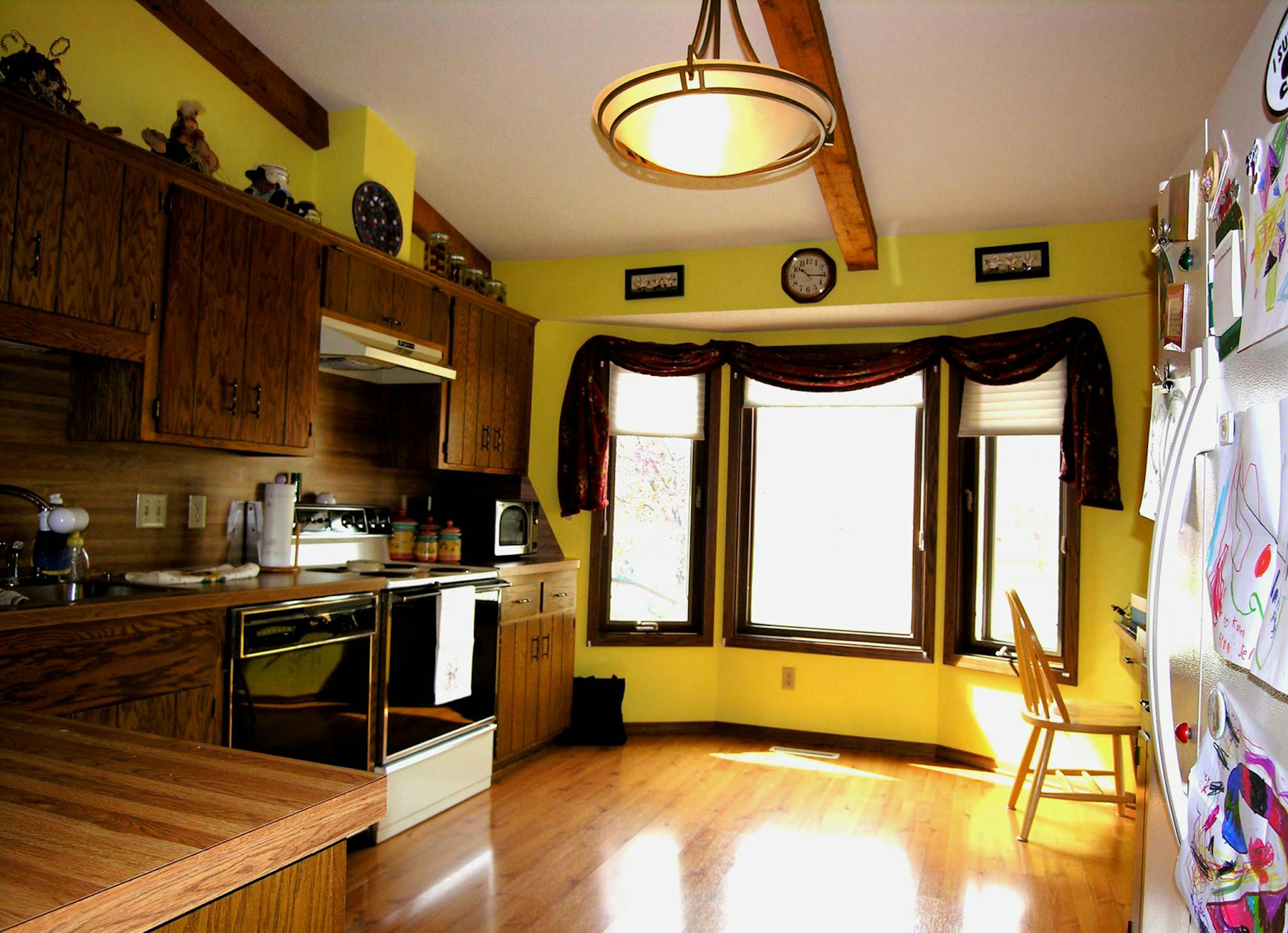 Before: Unflattering wall color and too much clutter