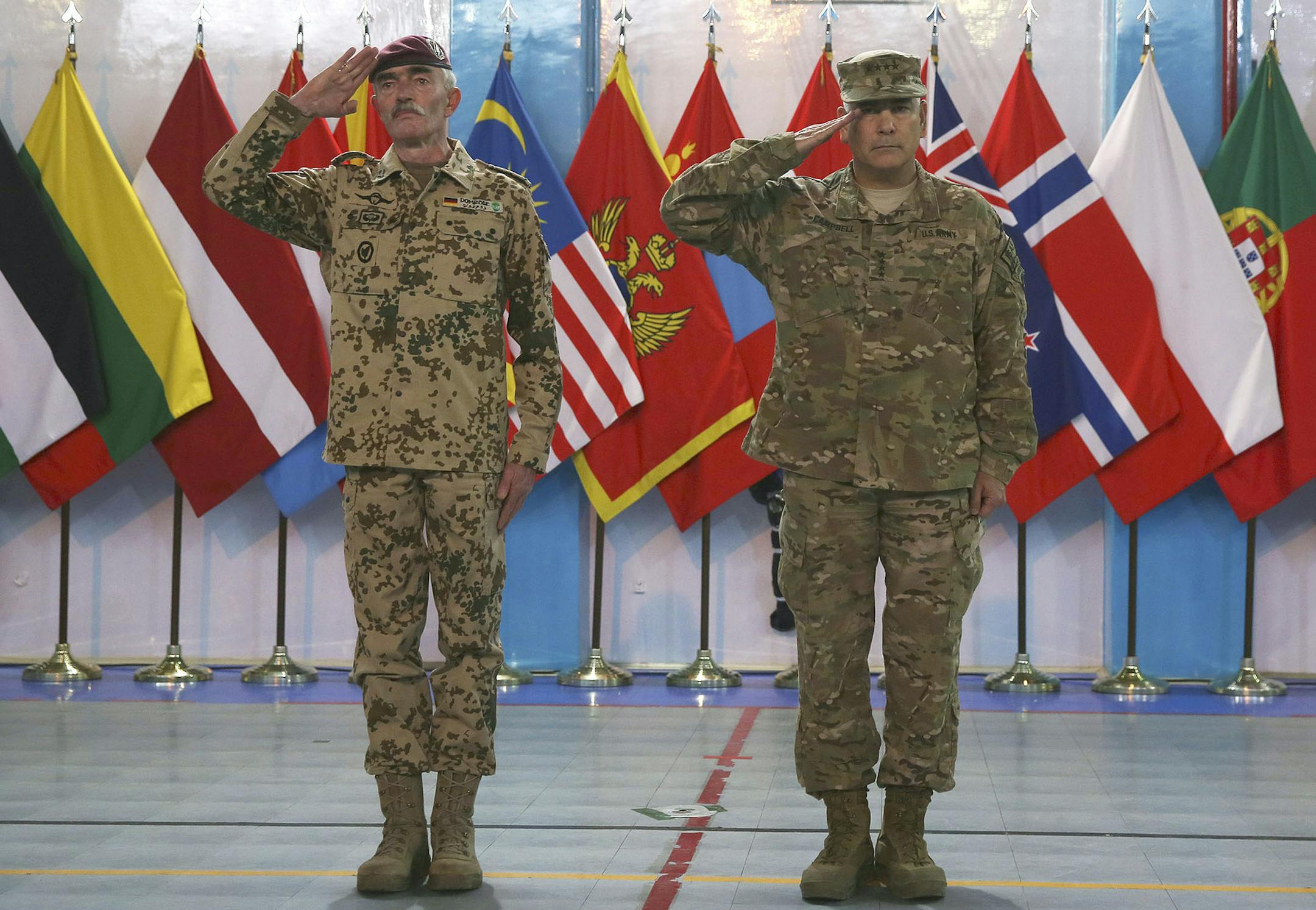 Commander of the International Security Assistance Force (ISAF), Gen. John Campbell, right, and ISAF Gen. Hans-Lothar Domrose attend a ceremony at the ISAF headquarters in Kabul, Afghanistan, Sunday, Dec. 28, 2014. The United States and NATO formally ended their war in Afghanistan on Sunday with the ceremony at their military headquarters in Kabul as the insurgency they fought for 13 years remains as ferocious and deadly as at any time since the 2001 invasion that unseated the Taliban regime fol