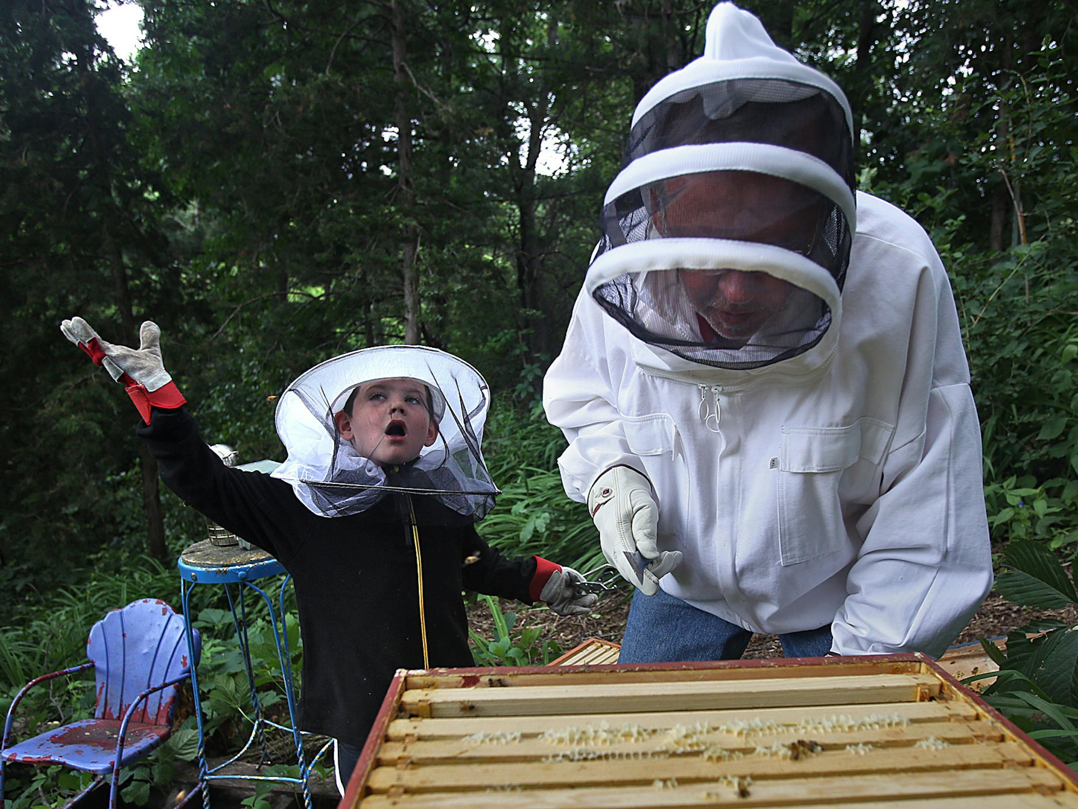 Beekeepers Jim and grandson Gus, 6, prepared to work with a colony of honey bees that the pair tend to at Jim&#x201a;&#xc4;&#xf4;s Minnetonka home. ] (JIM GEHRZ/STAR TRIBUNE) / July 5, 2013, Minnetonka, MN &#x201a;&#xc4;&#xec; FOR DUETS COLUMN