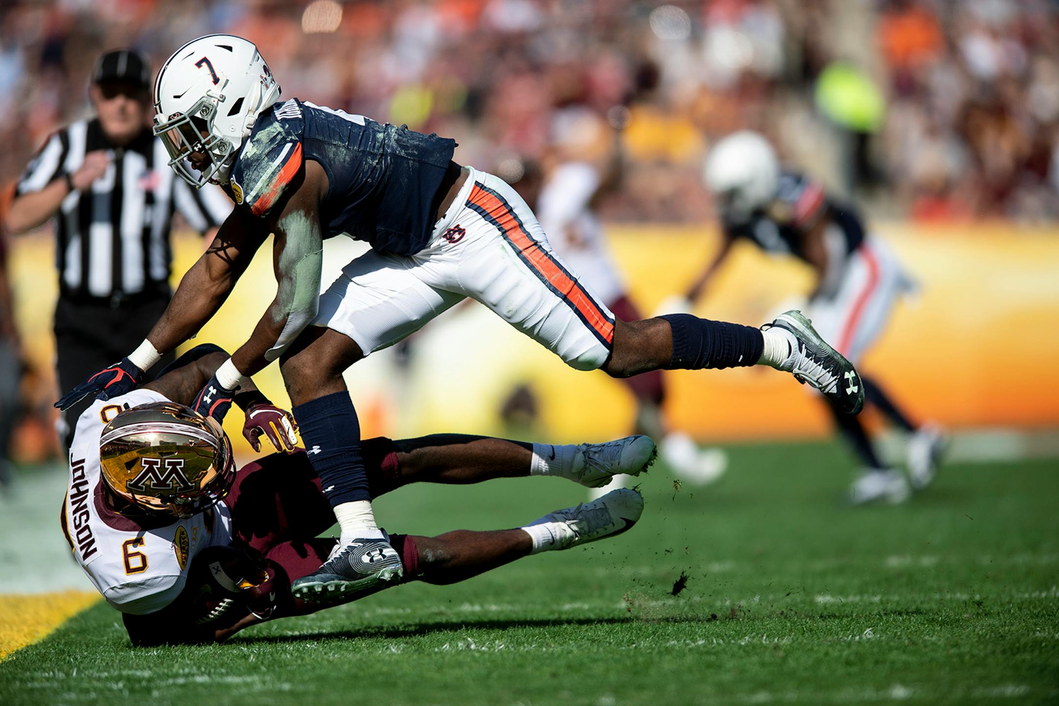 Minnesota Gophers wide receiver Tyler Johnson (6) was tackled by Auburn Tigers defensive back Noah Igbinoghene (4) after making a reception for first down in the first quarter.
