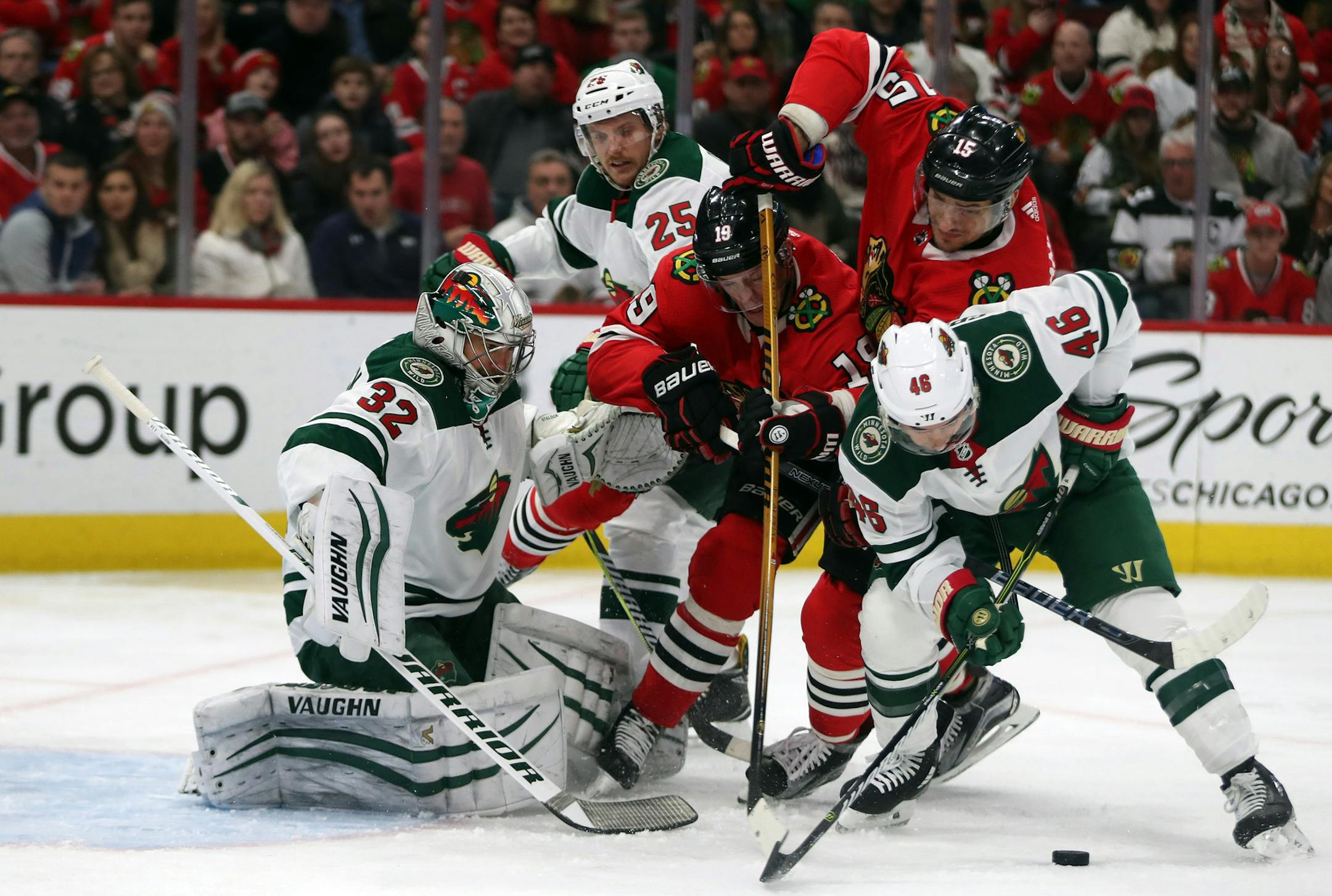 Chicago Blackhawks center Jonathan Toews (19) and Artem Anisimov (15) can't get to a puck in front of Minnesota Wild goalie Alex Stalock (32) and defenseman Jared Spurgeon (46) in the first period on Sunday, Dec. 17, 2017 at the United Center in Chicago, Ill. (Brian Cassella/Chicago Tribune/TNS) ORG XMIT: 1218801