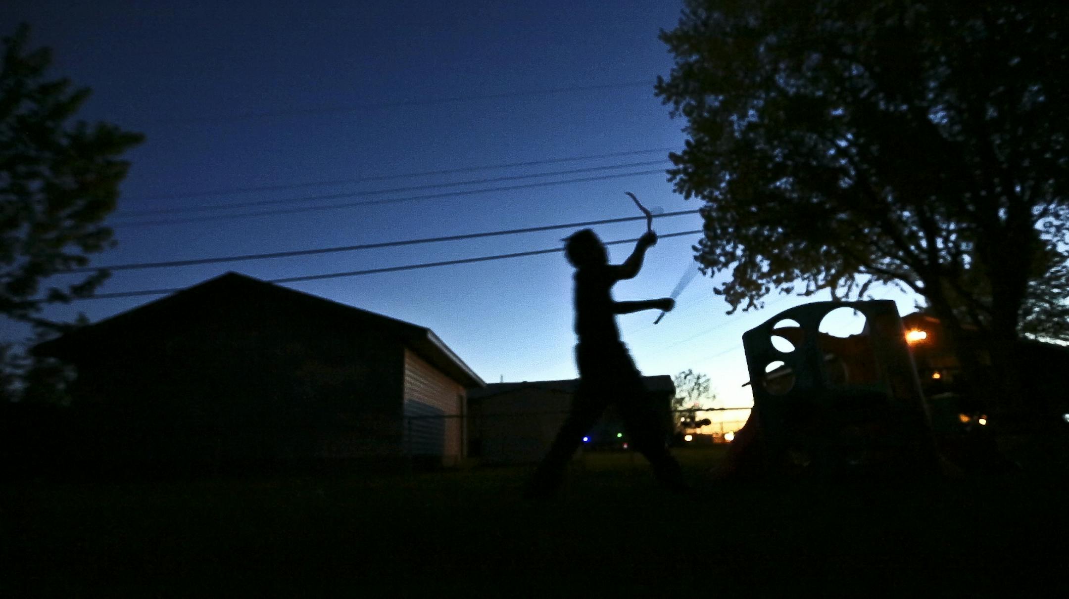 Gianni Griffin-Davis played an imaginary game with hangers in his backyard the evening he returned home from spending 37 days at the Ramsey County Juvenile Detention Center on Thursday May 23, 2013 in Fridley, Minn. ] (RENEE JONES SCHNEIDER * reneejones@startribune.com)