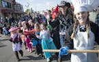 Costumed students and instructors from St. Stephens Elementary School waved to parade goers during Friday's Halloween parade along Main Street in Anok