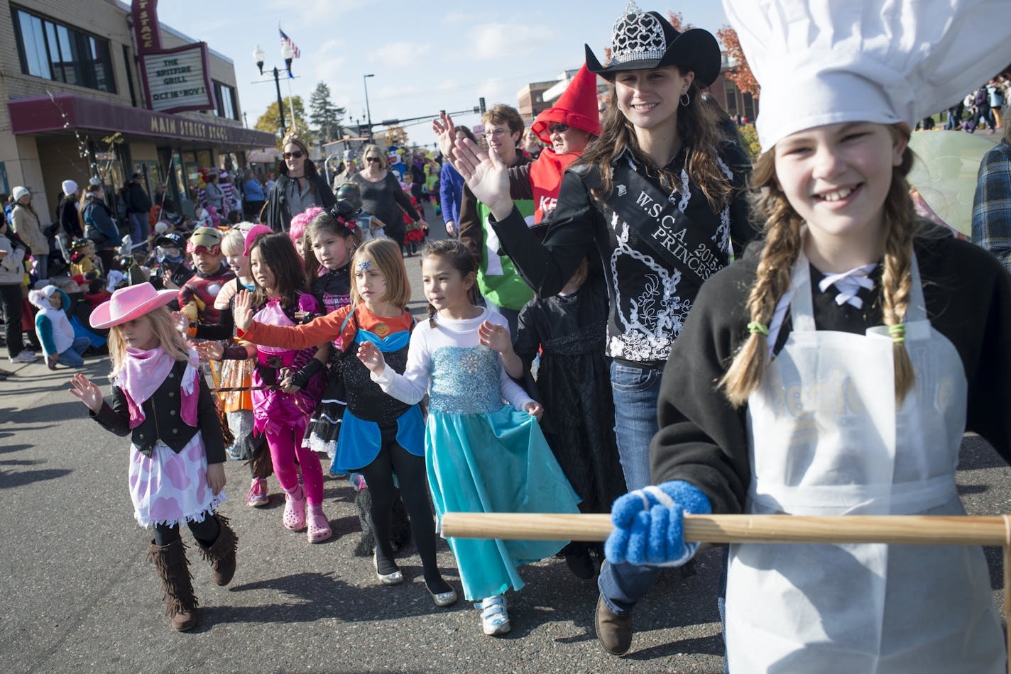 Costumed students and instructors from St. Stephens Elementary School waved to parade goers during Friday's Halloween parade along Main Street in Anoka.