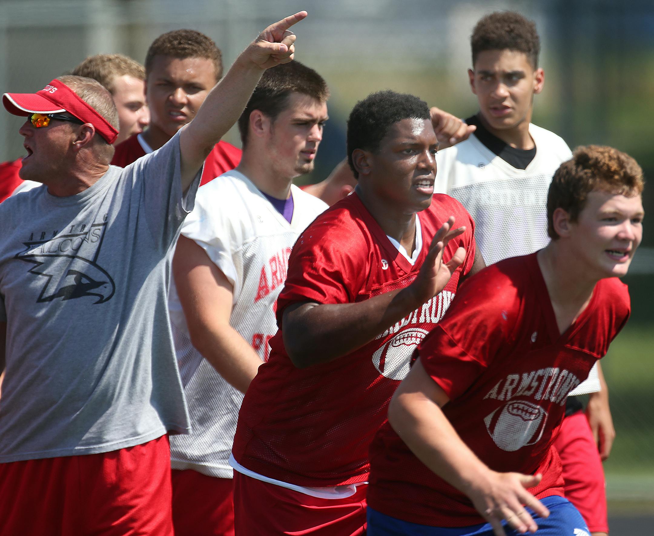 Armstrong head football coach Jack Negen (left) shouted instruction to players during a recent practice. Players included: Tru Thompson (top right); Thomas Barber (third from right) and Tommy Larson (fourth from right). ] JIM GEHRZ &#xef; james.gehrz@startribune.com / St. Paul, MN / August 14, 2015 / 12:00 PM &#xf1; BACKGROUND INFORMATION: Armstrong football practice at high school. Players to look for: Thomas Barber, Tru Thompson, Tommy Larson (offensive line).