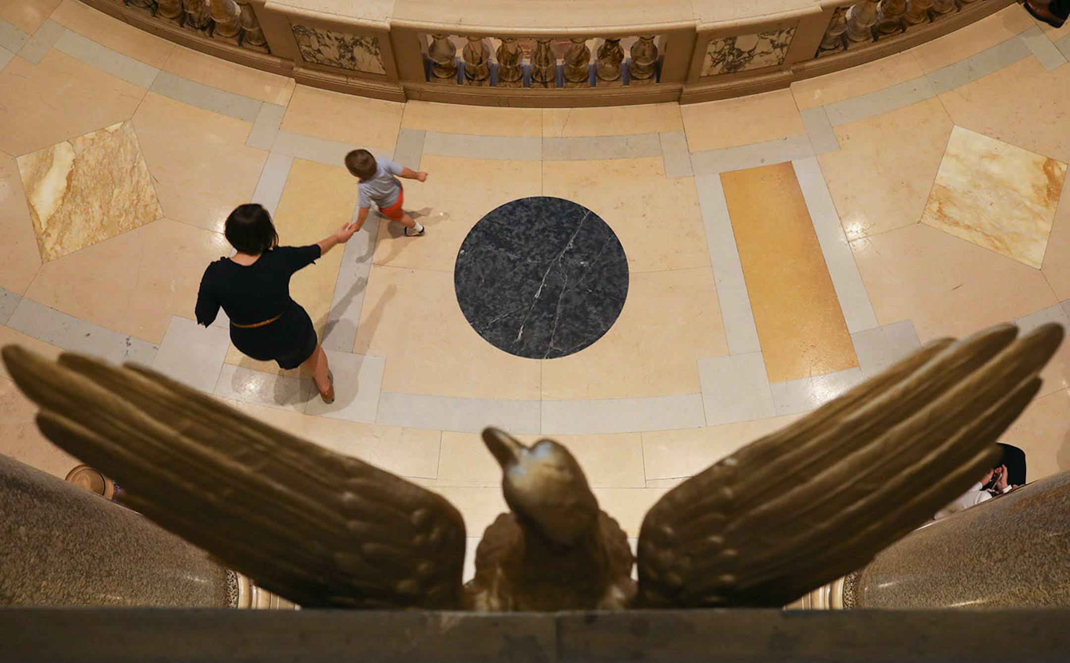 Andrea Perzichilli, a lobbyist at the State Capitol, high fived her 2 year-old son, Leo, as he ran laps around the rotunda while the House and Senate were in recess Monday evening.