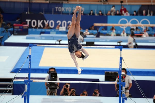 Suni Lee of the United States performs on the uneven bars during the women's all-around gymnastics competition at the postponed 2020 Tokyo Olympics in