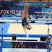 Suni Lee of the United States performs on the uneven bars during the women's all-around gymnastics competition at the postponed 2020 Tokyo Olympics in