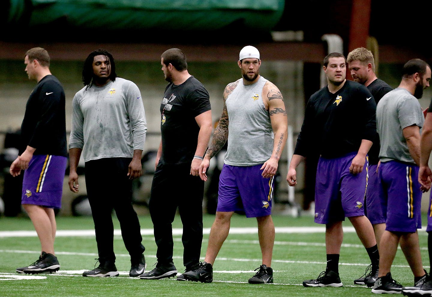 New Minnesota Viking Alex Boone, with hat, joined other Vikings for drills during a player offseason workout at Winter Park, Tuesday, April 26, 2016 in Eden Prairie, MN.