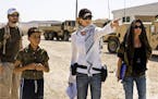 In this film publicity image released by Summit Entertainment, director Kathryn Bigelow, center, is shown on the set of "The Hurt Locker." Bigelow was