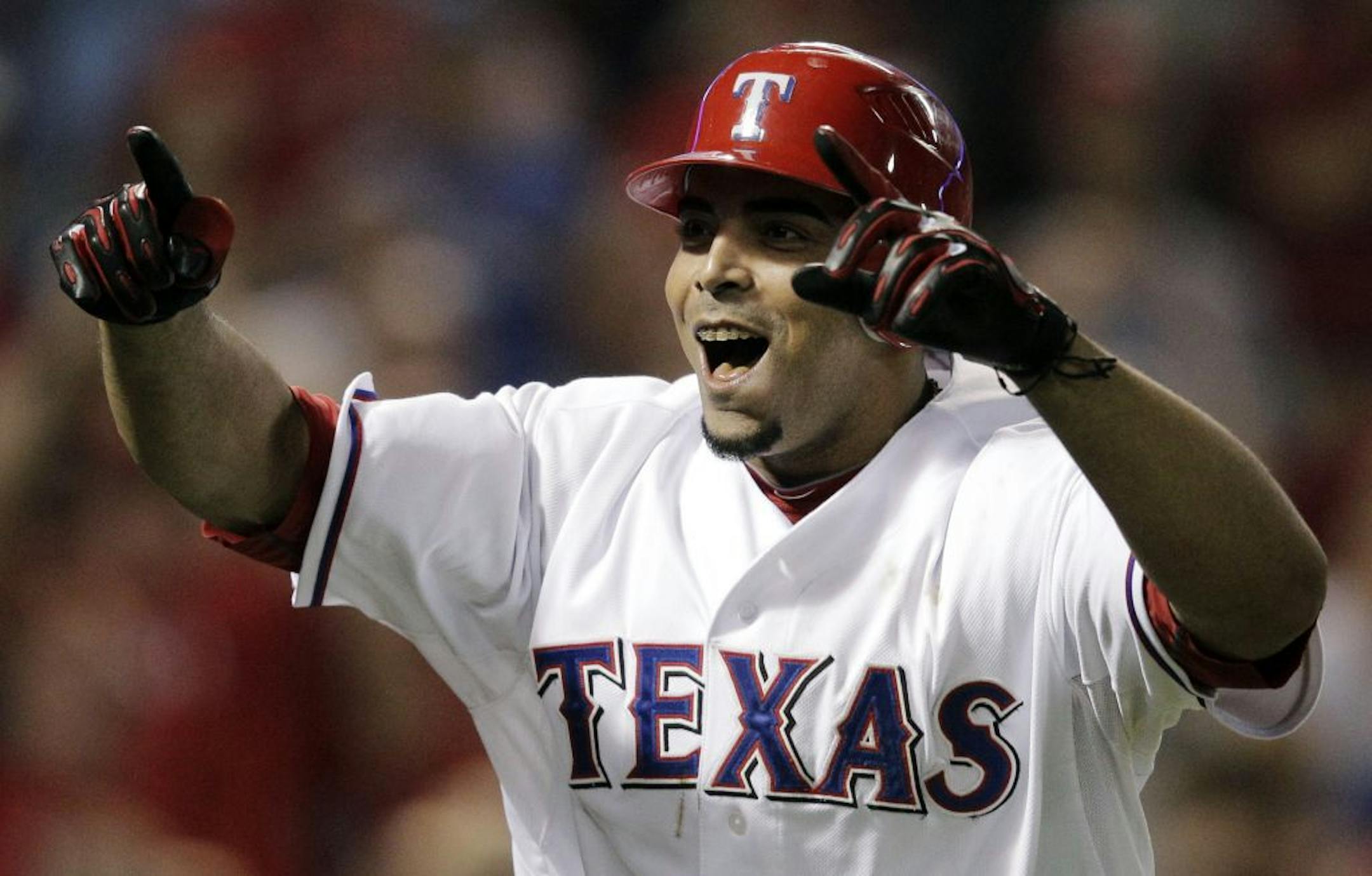 The Texas Rangers' Nelson Cruz reacts after hitting a two-run home run against the Detroit Tigers during the seventh inning at Game 6 of baseball's American League championship series Saturday, Oct. 15, 2011, in Arlington, Texas.