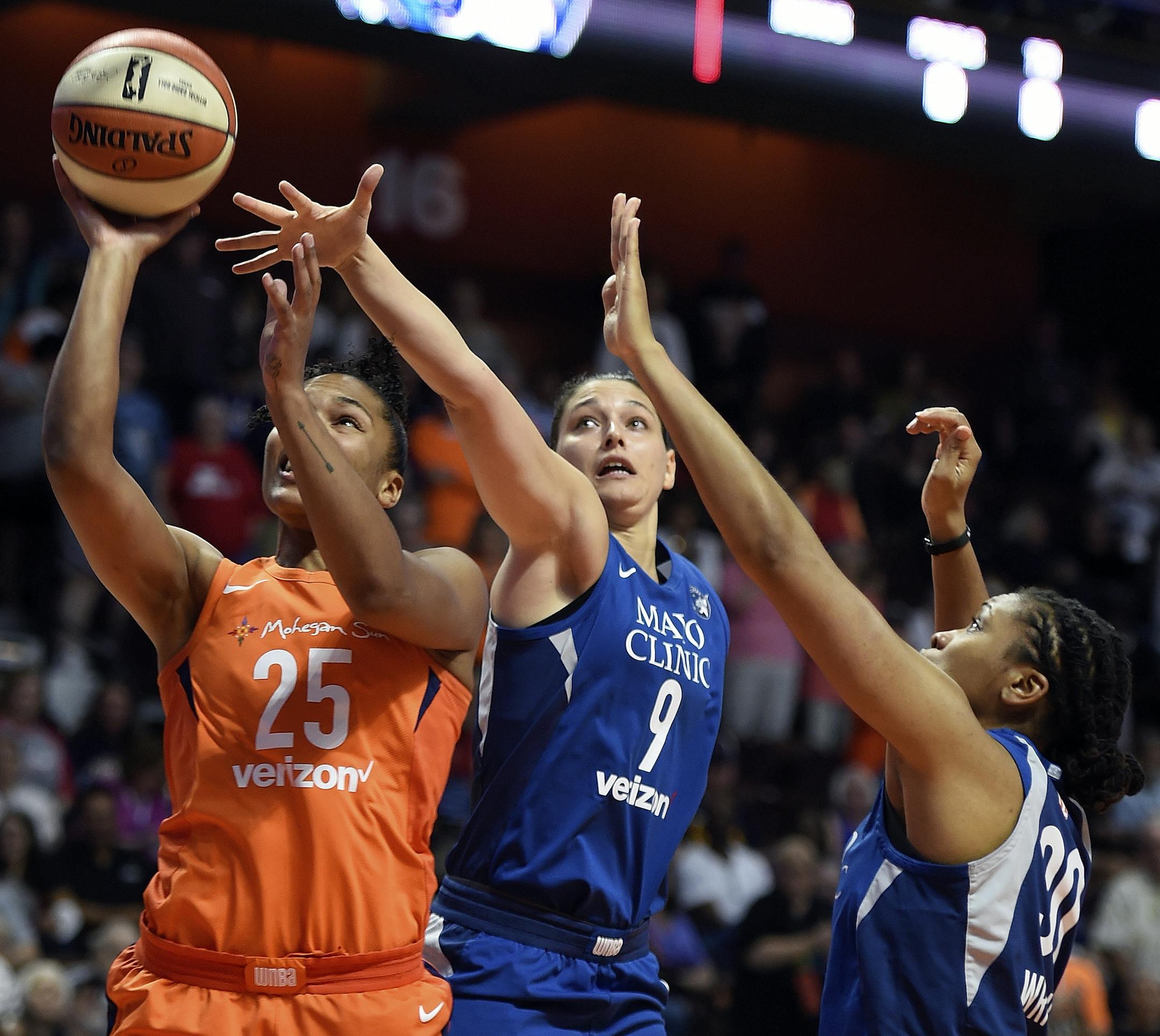 Connecticut Sun forward Alyssa Thomas (25) drives by Minnesota Lynx defenders Cecilia Zandalasini (9) and Tanisha Wright during the first half of a WNBA basketball game Friday, Aug. 17, 2018, in Uncasville, Conn. (Sean D. Elliot/The Day via AP)