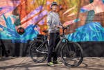 Luke Breen, owner of Perennial Cycle in Uptown Minneapolis, flashes a Gazelle Ultimate C380+ electric bike from the store.