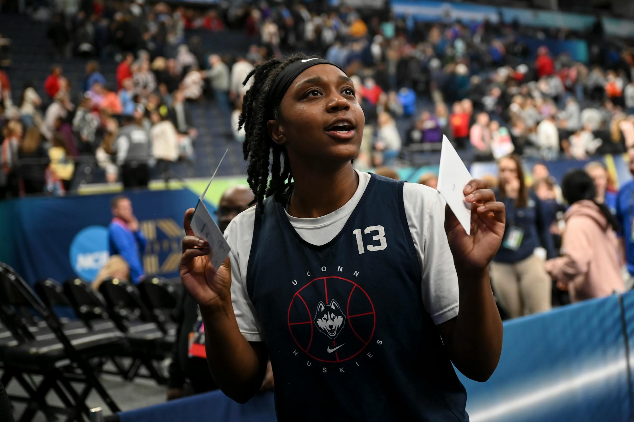 UConn guard Christyn Williams (13) looked to deliver a few signed cards to young fans who disappeared after a Final Four open practice held Saturday, April 2, 2022 at Target Center in Minneapolis, Minn.