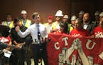 Flanked by union members, Minneapolis mayor Jacob Frey speaks in support of an initiative to crack down on wage theft.