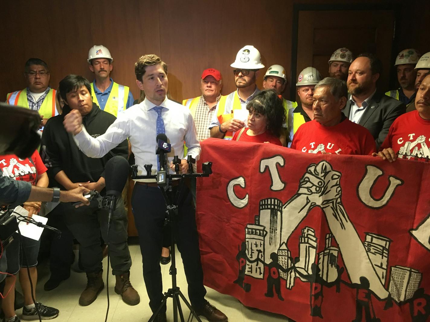 Flanked by union members, Minneapolis mayor Jacob Frey speaks in support of an initiative to crack down on wage theft.