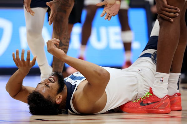 Karl-Anthony Towns of the Wolves was in pain after being fouled in the first quarter against the Nuggets tonight in Denver.
