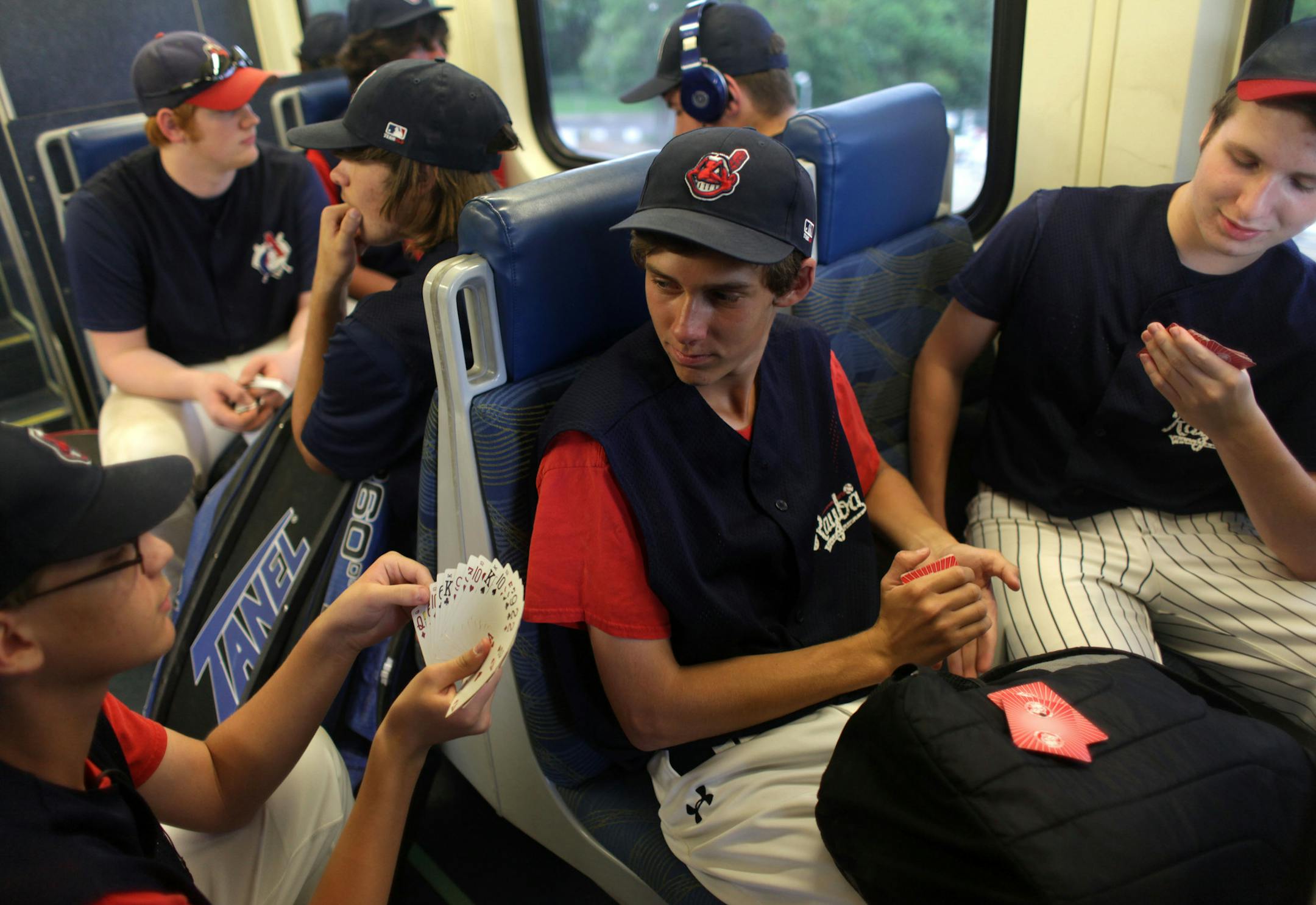 Josh Lehnertz, Tony Langfellow, and Steven Peterson play cards on the commuter train from Fridley to Big Lake on Monday afternoon. A team of 16 year old baseball players for the Armstrong Cooper Raptors took the Northstar commuter train from Fridley to Big Lake for their game on Monday afternoon, though the game was rained out. ] MONICA HERNDON monica.herndon@startribune.com Fridley, MN 07/07/14
