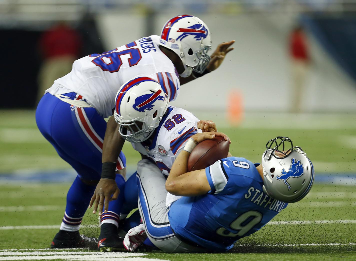 Detroit Lions quarterback Matthew Stafford (9) slides in as Buffalo Bills inside linebacker Preston Brown (52) makes the tackle during an NFL game at Ford Field in Detroit on Sunday, Oct. 5, 2014. (Jeff Haynes/AP Images for Panini)