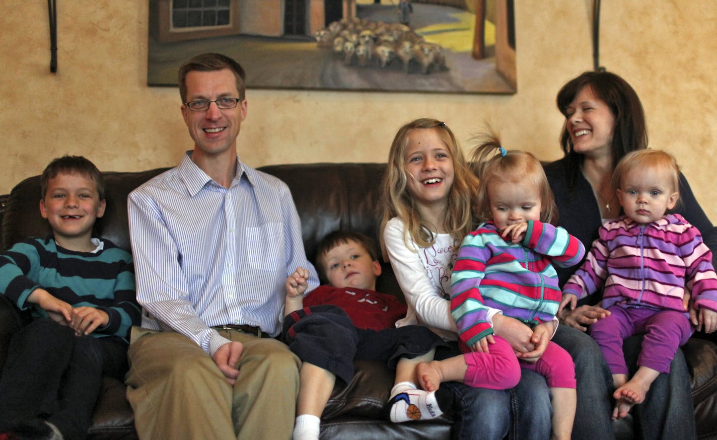 The Slaven family at home Saturday, March 30, 2013, in Plymouth, MN, including Joseph, 6, left to right, dad Shawn, Caleb, 3, Adelaide, 9, holding twin Claire, 21 months, and mom Julie holding Hannah, 21 months.](DAVID JOLES/STARTRIBUNE) djoles@startribune.com A Plymouth couple sued Hennepin County Court, citing a lack of due process for parents accused of child abuse recently lost their case on appeal, but vow to continue a fight against procedures which they say don't allow parents to defend t