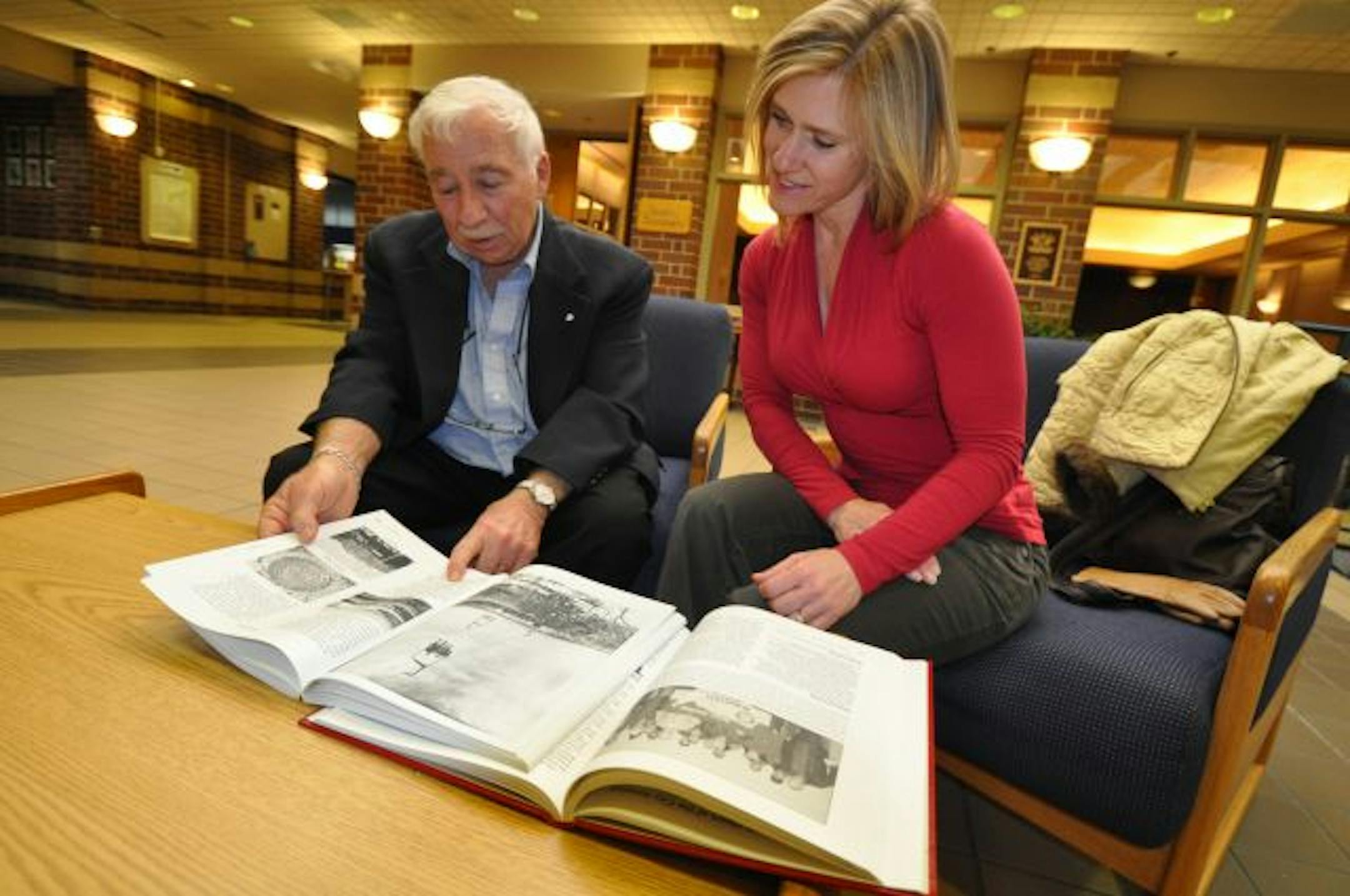 Len Nachman told stories to fellow Burnsville resident Dawn Ridgway as they paged through two history books about the community. Nachman and his wife, Mimi, contributed to both books