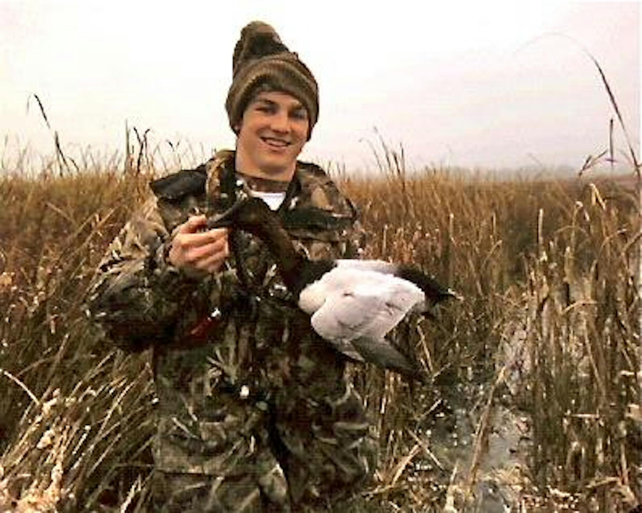 Dominic Schneider and a bull canvasback he took Sunday morning on a lake just north of the Twin Cities.
