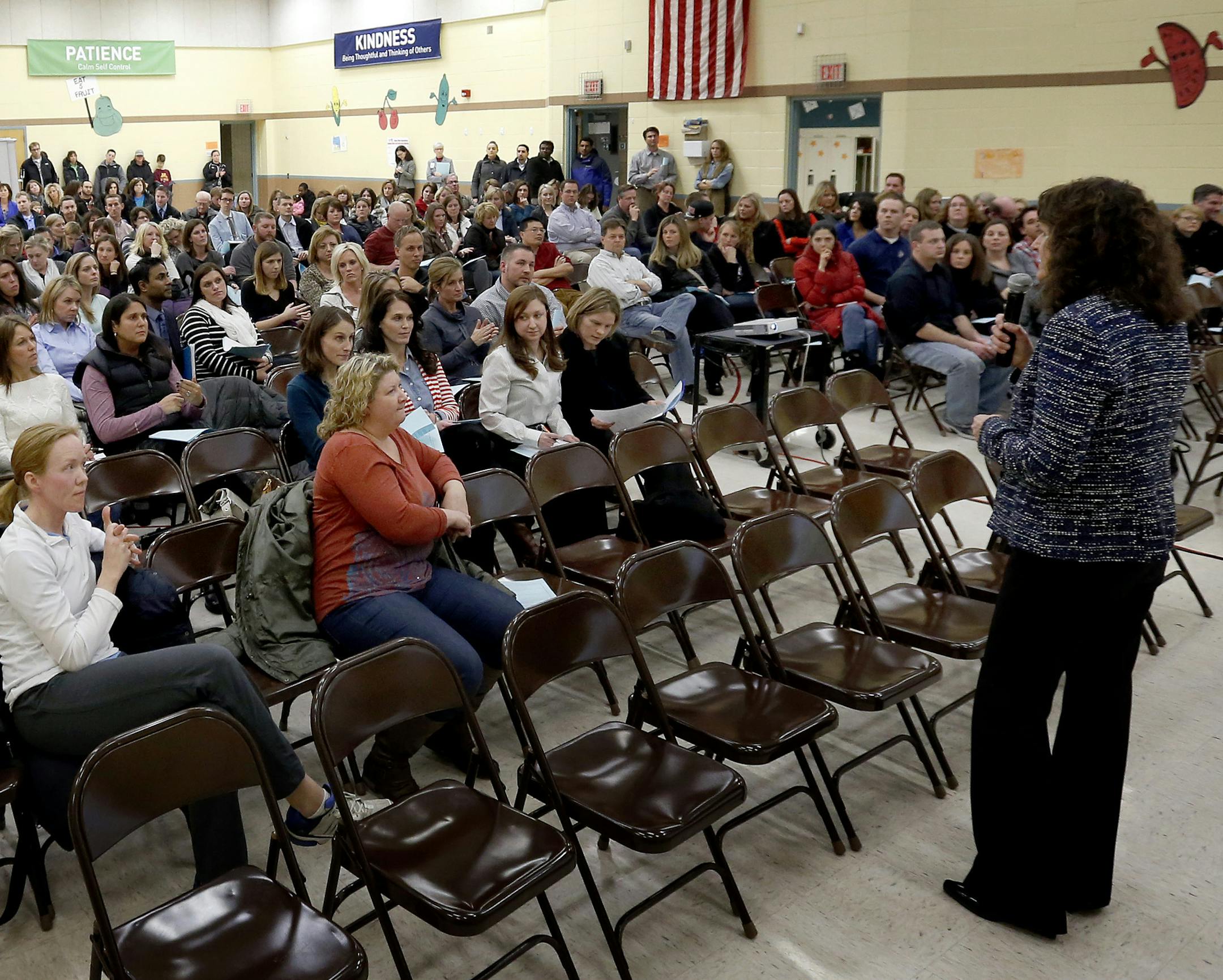 Osseo Schools Superintendent Kate Maguire fielded questions during a meeting with parents in the gym of Basswood Elementary School in Maple Grove on Tuesday evening. ] CARLOS GONZALEZ cgonzalez@startribune.com - January 14, 2013, Maple Grove, Minn., Basswood Elementary School, Residents of five well-to-do neighborhoods near Plymouth are concerned over the fact that Osseo Area Schools wants to move them to another elementary school, one that is decidedly less white or affluent. The move is part o
