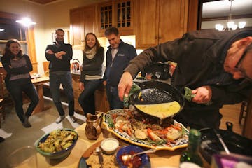 Two families, their children and occasionally friends have been dining together weekly for about 30 years. Here, Don Luce prepares the chicken dish as