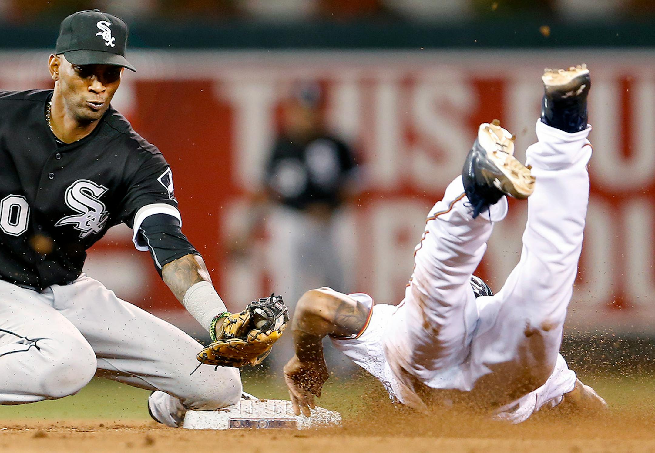 Alexei Ramirez (10) tagged out Byron Buxton (25) as he attempted to steal second base in the seventh inning Tuesday at Target Field. He injured his thumb on the play.