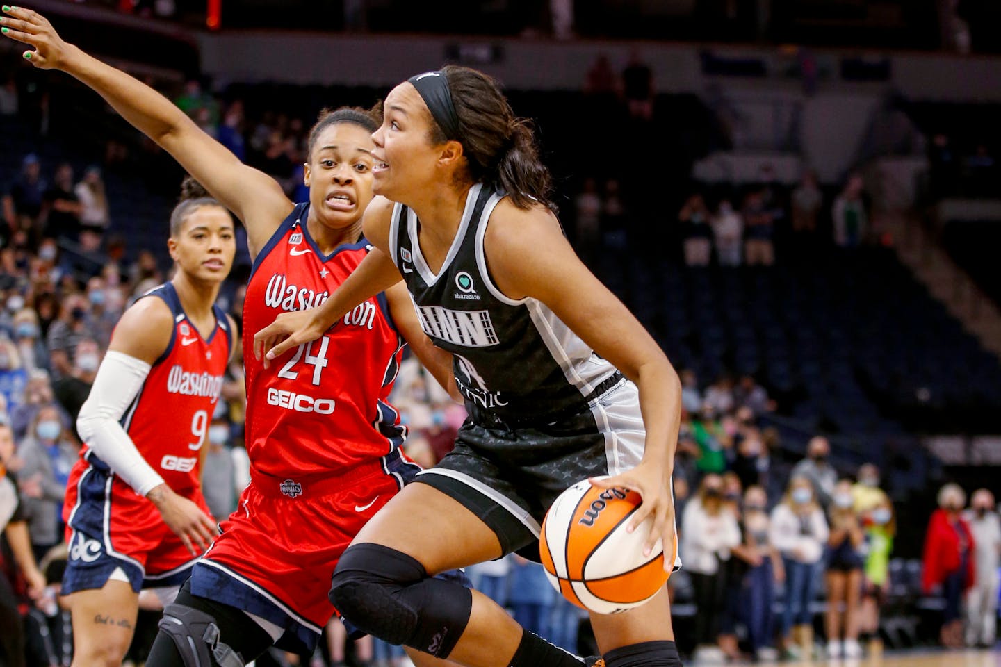 Washington Mystics forward Erica McCall, middle, defends against Lynx forward Napheesa Collier during a game on Sept. 4. The Lynx won vs. Washington on Sunday.